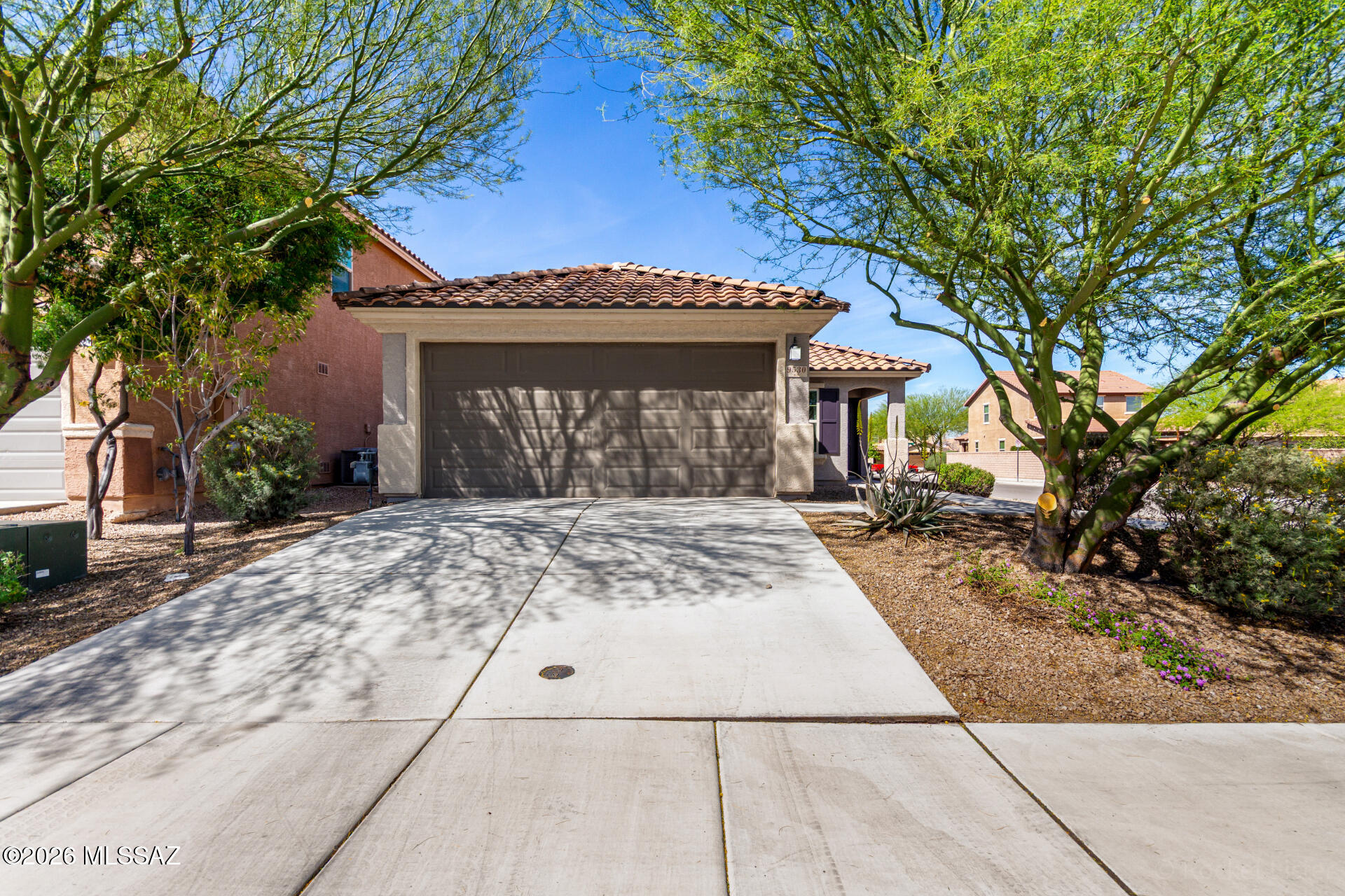 A desirable home on a corner lot! Lovely curb appeal with attractive desert landscaping + a 2-car garage greets you upon arrival. Discover a bright interior featuring open common areas, soft carpet underfoot, and custom paint finishes. The kitchen showcases gorgeous cabinetry, stainless steel appliances, a walk-in pantry, ample counter space, and tile backsplash. Fabulous main bedroom is highlighted by a charming wainscoting accent wall paired with designer wallpaper, a walk-in closet, and a private bathroom complete with a dual sink vanity and a tub/shower combination. Enjoy an easy-care backyard with a covered patio and a cozy firepit area. You won't be disappointed! Hurry!