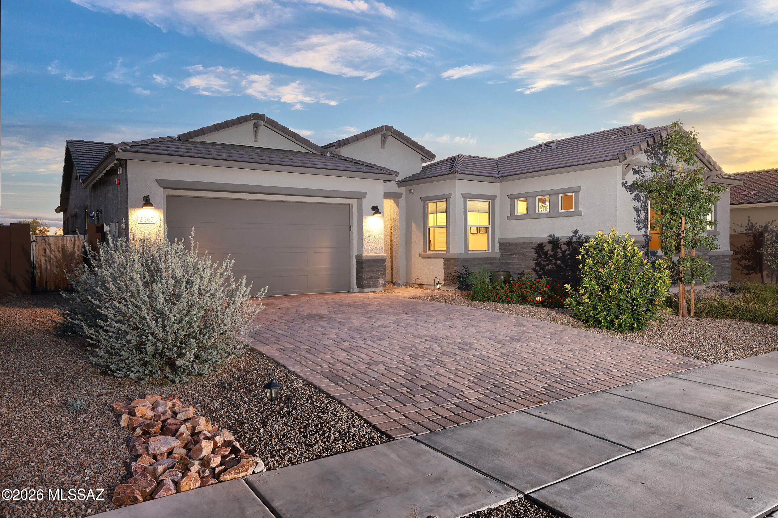 Freshly updated with new wide-plank luxury vinyl flooring, this exceptional home offers expansive desert and mountain views and a highly desirable Next Gen suite--an increasingly rare combination in today's market. Backing to open space, the property captures the beauty and privacy of Arizona living while providing flexible space for multigenerational living, guests, a home office, or hobbies.  4 bedrooms, 3.5 baths, a 2-car garage, and 2,950 sq. ft. of thoughtfully designed living space.  Inside, soaring 10' ceilings, recessed lighting, tile flooring, Luxury Vinyl Planks and soft carpet in the bedrooms create a comfortable and inviting atmosphere. The dining room flows into the spacious great room with a sleek LED fireplace and a 16' multi-panel slider that seamlessly blends indoor and outdoor living.
The kitchen is designed for gathering and entertaining with a large granite island with extra cabinetry, gas cooktop with double ovens, stainless steel appliances, microwave, lazy Susan, oversized walk-in pantry, and casual dining café with its own patio slider.
The spacious primary suite offers a spa-inspired bath with dual shower heads, quartz vanities, and a generous walk-in closet. Additional features include a powder room, dedicated laundry room with washer and dryer, and plumbing for a utility sink.  This wonderful home is ready to be yours!