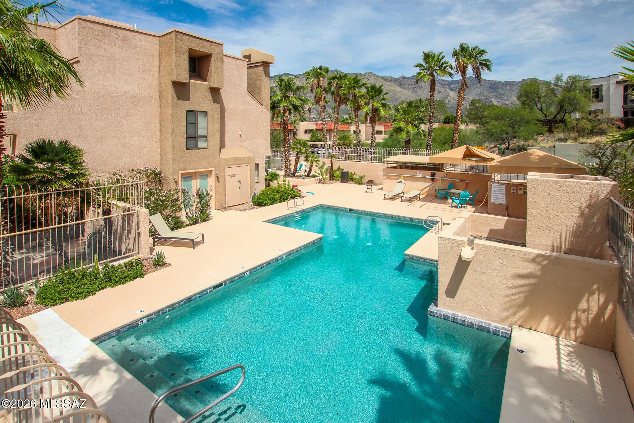 Desirable Dakotah Hills condo in an exclusive gated community in the heart of the Catalina Foothills! This ground-level end unit features a split-bedroom floor plan, tile flooring throughout, tall ceilings, and a wood-burning fireplace. The primary suite offers two closets and a sliding glass door to the private back patio. New A/C installed in 2024. Enjoy mountain views, beautiful landscaping, walking paths, grilling areas, a heated pool, and multiple spas. Ideally located near fine dining, grocery stores, gyms, shopping, and everyday conveniences, with easy Foothills access. Located in the Catalina Foothills School District--a perfect blend of location, comfort, and Foothills living.