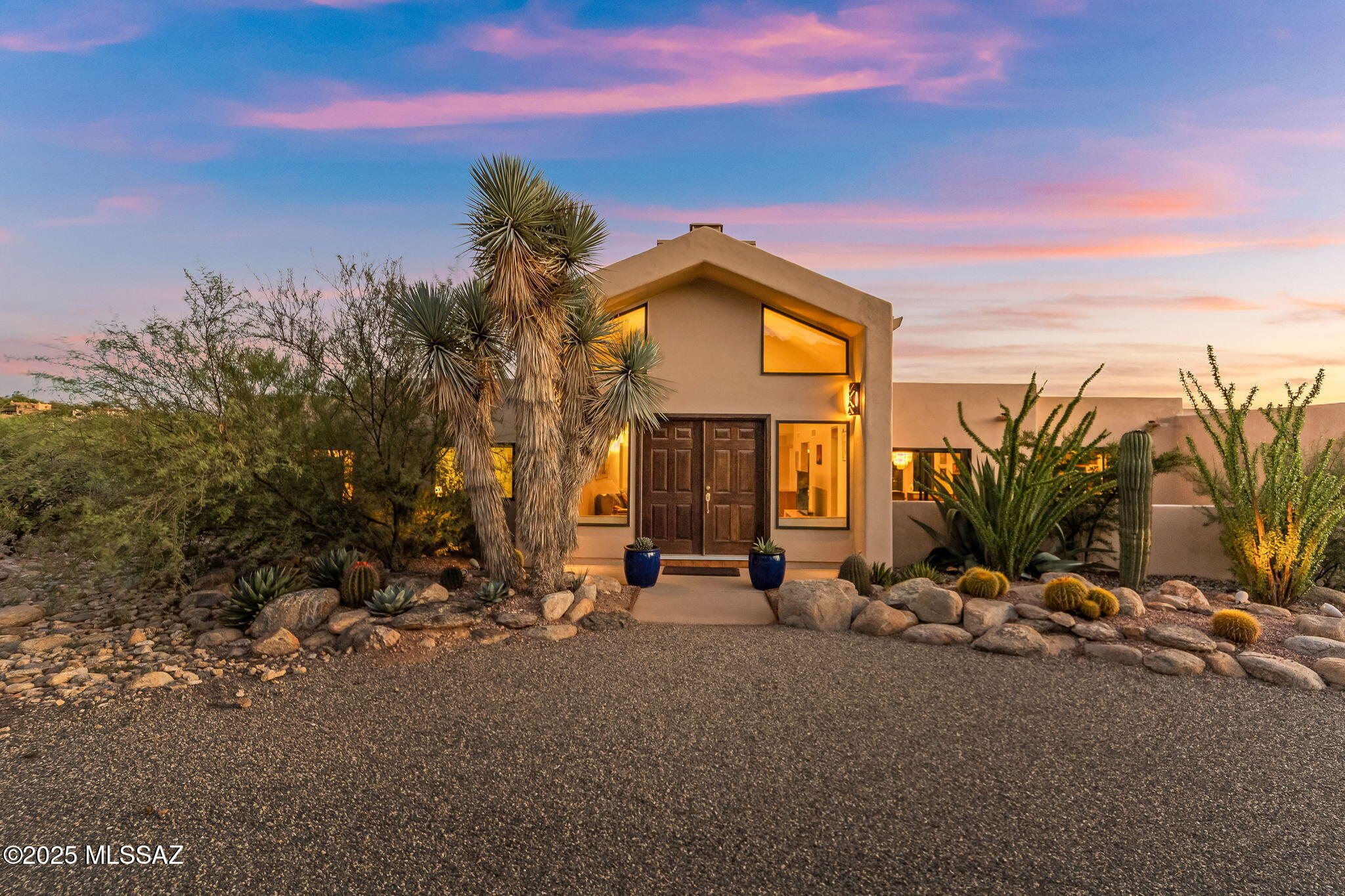 Beautifully kept foothills home in the desirable Sin Vacas neighborhood, featuring a grand entryway framed by mature desert landscaping. Set on a generous .87-acre lot, this 3 bedroom and 3 full baths residence offers mountain views from both the dining room and kitchen areas plus tranquil desert vistas from the private covered back patio. Spacious rooms with high ceilings create an open, elegant feel, with plenty of room for entertaining both indoors and out. Enjoy two fireplaces, one in the living room and one in the family room. The open kitchen with breakfast area, large laundry room, and a 2-car garage add everyday convenience. Take in stunning sunsets and sparkling city lights at night. A fabulous value in the heart of the Catalina Foothills!