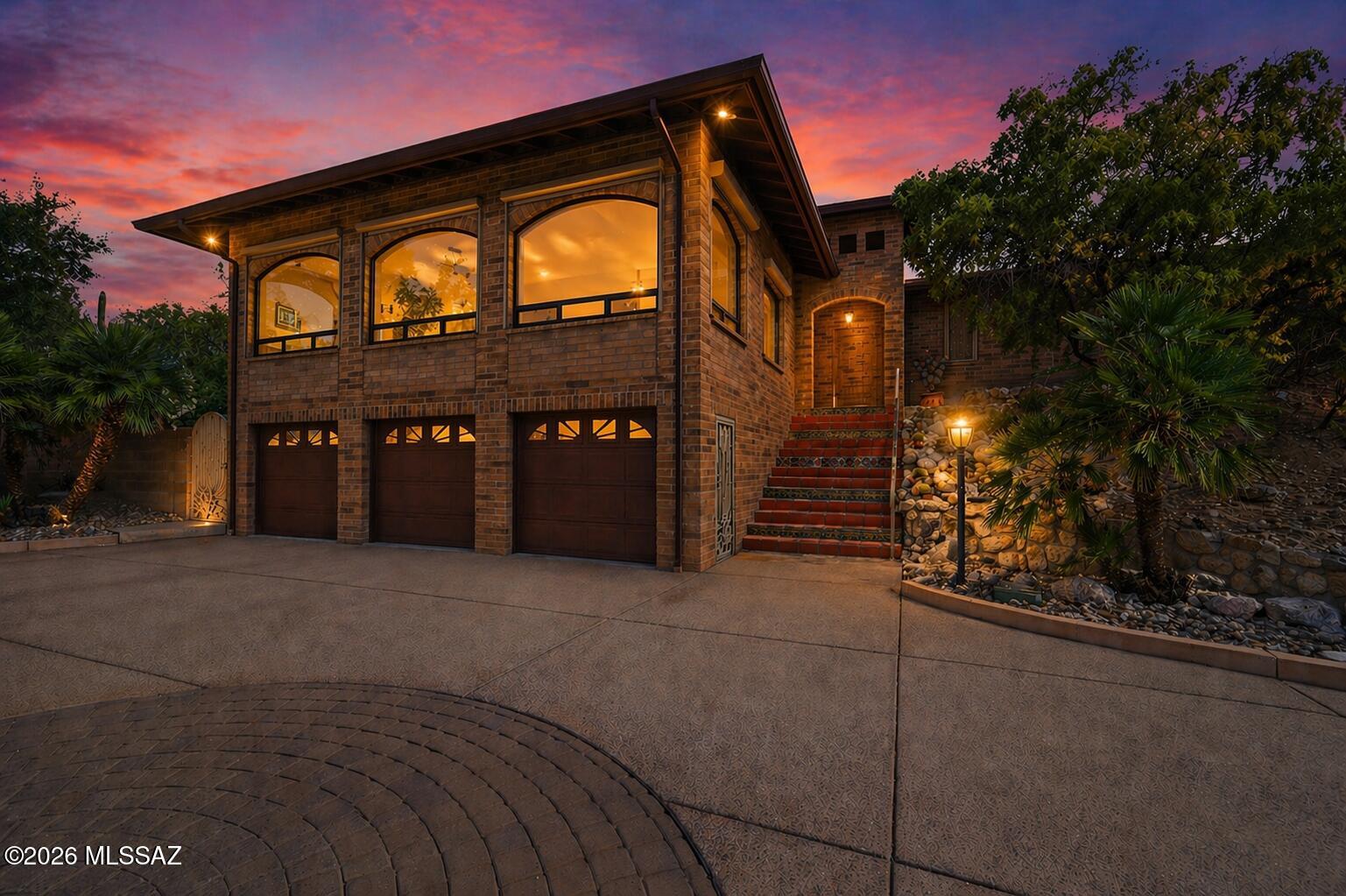 Perched in the coveted Catalina Foothills, this exceptional Tucson residence offers a rare blend of refined luxury, privacy, and breathtaking natural beauty. Showcasing sweeping 360-degree views of the surrounding mountains and sparkling city lights, this home is a true desert retreat designed for both relaxation and elevated entertaining.

This thoughtfully designed home features 3 spacious bedrooms and 2 beautifully appointed bathrooms, along with a rare and expansive 3.5-car garage--perfect for car enthusiasts, storage, or a home workshop.

Inside, timeless elegance meets modern comfort with rich wood flooring, cool travertine tile, and thoughtfully curated finishes throughout. The gourmet kitchen is a chef's dream, showcasing stunning granite countertops, expansive prep space, and a seamless connection to the home's main living areas, complete with a well-appointed wet bar featuring a granite sink--perfectly designed for elevated entertaining.

The primary suite is a private sanctuary, complete with its own patio overlooking the city, where a cozy gas fire pit and tranquil fountain create the perfect setting for morning coffee or evening unwinding under the stars. From this serene vantage point, enjoy captivating views of iconic A Mountain, adding a distinctive Tucson backdrop to your everyday retreat.

The front courtyard offers a charming and private welcome, featuring a beautiful gazebo perfectly positioned to capture up-close, unobstructed views of the Catalina Mountains, including Finger Rock--an ideal setting for quiet mornings or sunset gatherings.

Step outside to experience resort-style living at its finest. The expansive outdoor space is designed for entertaining, with a sparkling pool, a fully equipped barbecue and bar area, and multiple patios that capture Tucson's iconic sunsets and panoramic vistas. A striking waterfall feature welcomes you at the front entry, setting the tone for the serene ambiance found throughout the property.

Additional features include security roller shades for peace of mind and energy efficiency, as well as a whole-home generator, ensuring comfort and reliability year-round.

This is more than a home--it's a lifestyle defined by luxury, views, and the beauty of the Sonoran Desert.
