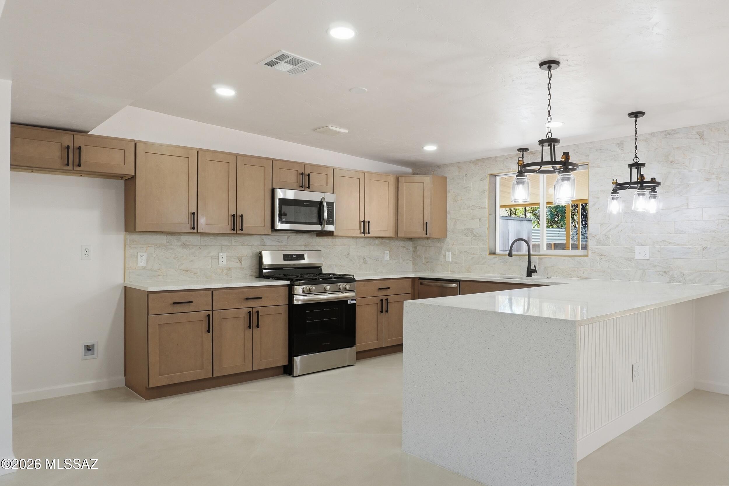 Seller will entertain offers $350,000-$360,000. Completely redesigned home in morning view subdivision (close to Blenman Elm and U of A)  Expansive open kitchen with all new appliances and quartz counter tops. This home shouts perfection the minute you walk in.  LOCATION, LOCATION, LOCATION! Amazing custom concrete floors, new carpet in the bedrooms, all new texture on the walls, new lighting and bathrooms. Put this one at the top of your list. Owner/Agent