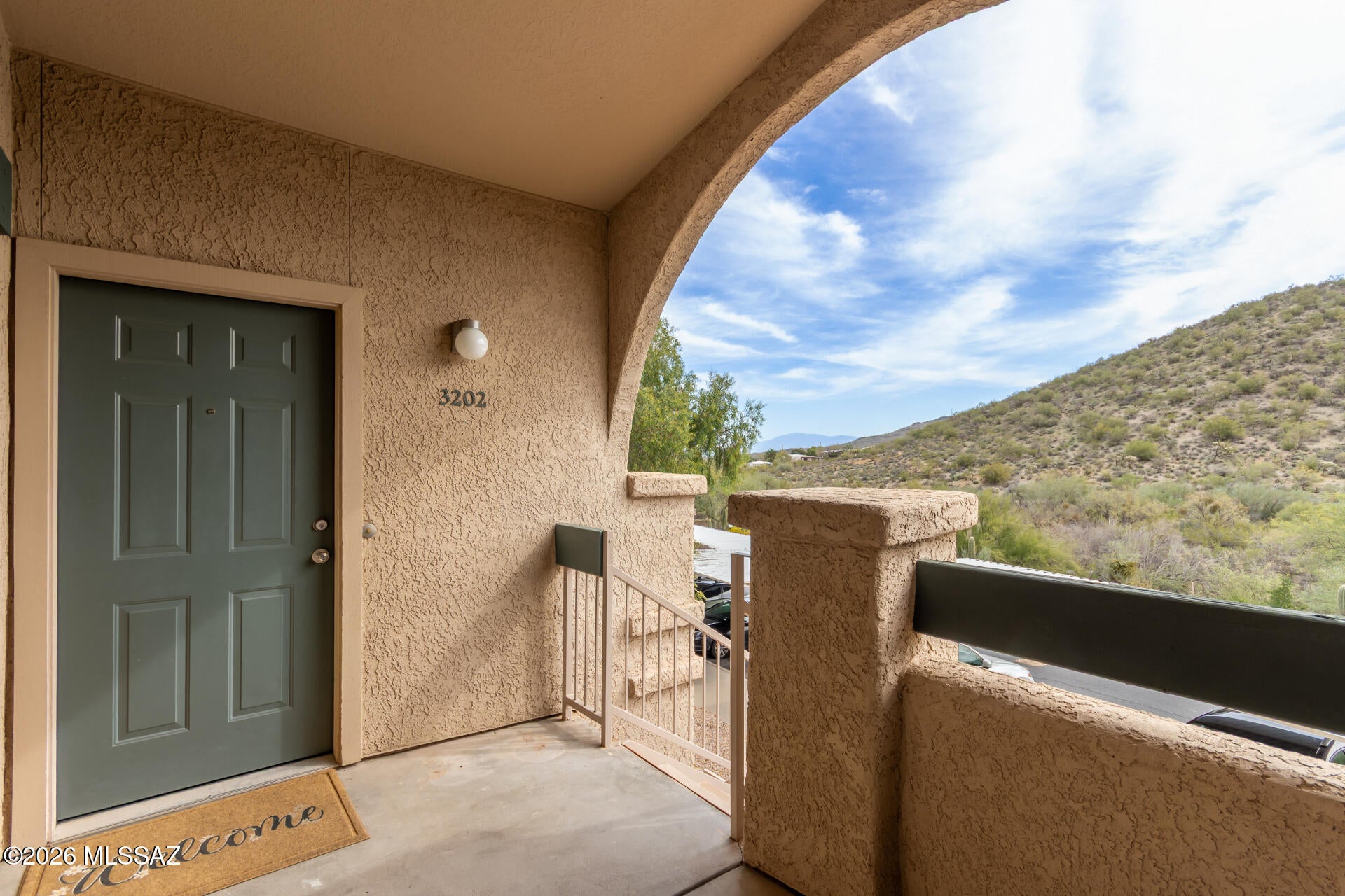 A condo with a VIEW!! Tucked away at the back of this exclusive luxury community, this exceptional residence offers privacy, tranquility, and breathtaking natural surroundings. Unwind on your private balcony as you watch wildlife roam the hillside and meander through the wash. Inside, you'll find a spacious, light-filled retreat with an inviting open feel. Cozy up by the crackling fireplace on cool winter evenings, then spend sunny days relaxing beside the sparkling resort-style pool. Whether you're searching for a year-round residence or the perfect seasonal escape from harsh winter weather, this beautifully appointed condo offers the ideal blend of comfort, elegance, and serene desert living.
