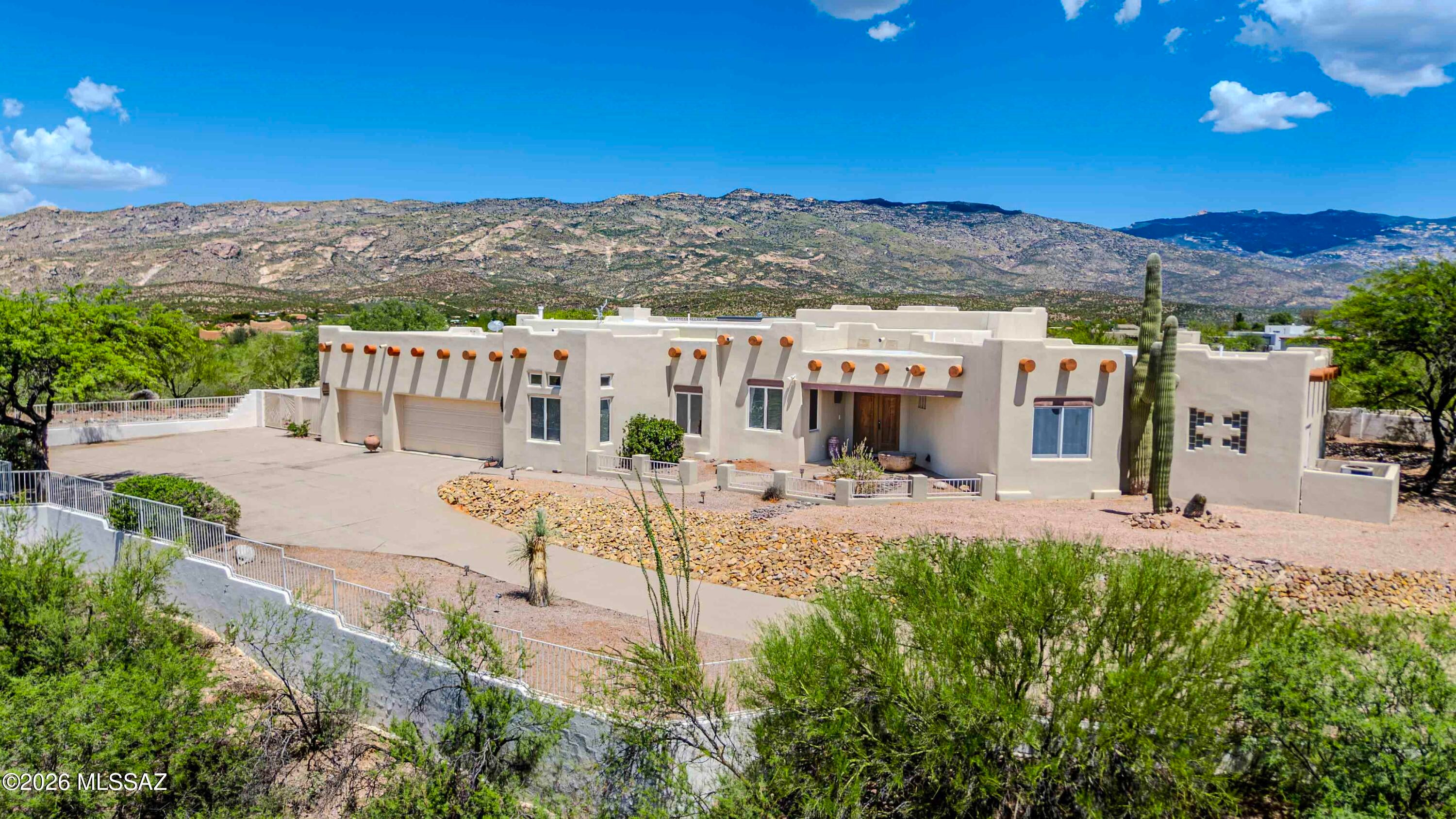 Nestled on nearly an acre in the desirable Rincon Desert Estates, this exceptional Santa Fe-style custom home offers the perfect blend of privacy, space, and breathtaking mountain views. Featuring approximately 3,160 square feet, this single-level residence includes 4 spacious bedrooms and 3 bathrooms. A thoughtfully designed floor plan ideal for comfortable living and entertaining with a cozy guest den area outside two of the bedrooms. The inviting family room showcases one of two fireplaces, flowing seamlessly from the kitchen, creating the perfect gathering space. The primary suite offers a private retreat with its own fireplace, spa like bathroom and spacious closet. Step outside to enjoy the expansive covered patio, low-maintenance desert landscaping, and panoramic mountain views.