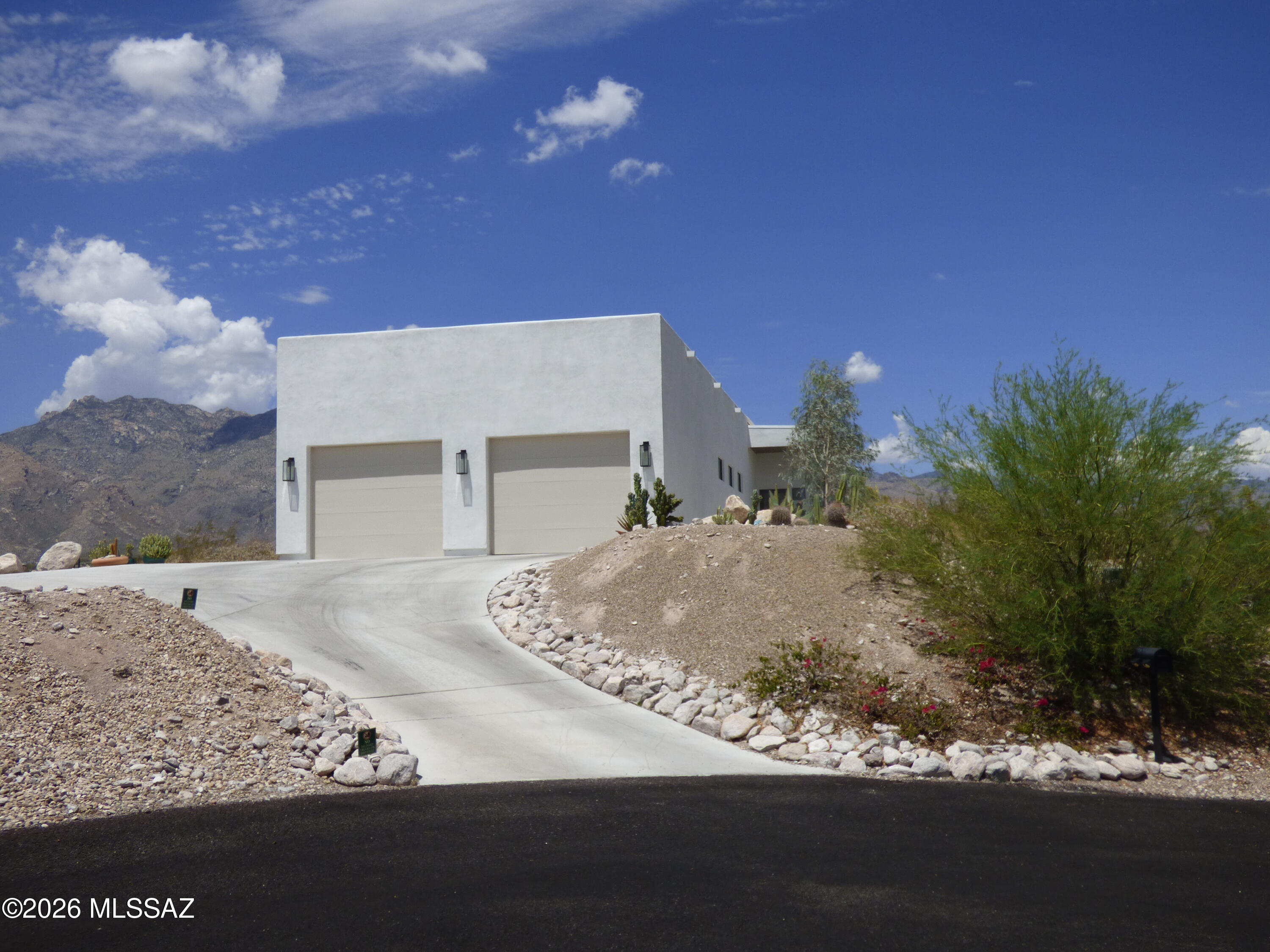 PRISTINE AND PRIVATE HILLTOP BEAUTY!
This 3BD/2BA, 2702 sq ft custom built 2023 stunning home has many features including 12 ft ceilings throughout main living area, primary bedroom/bathroom, den and entry ways, 8 ft tall doors throughout, custom cabinetry, recessed lighting, hunter ceiling fans, engineered hard wood floors, marble tiled bathrooms, quartz countertops in kitchen and bathrooms, large marble island and water softener.
Primary bathroom has large walk-in shower, floating vanity w/ two sinks, and soaking tub. 
Secondary bedroom is an en suite with attached bathroom with walk-in shower. 
Large 672 sq. ft 2 car garage, Large covered back patio with 12-foot cantilevered covering and amazing Tucson city and Catalina Mountains views included!
*FURNISHINGS NOT INCLUDED