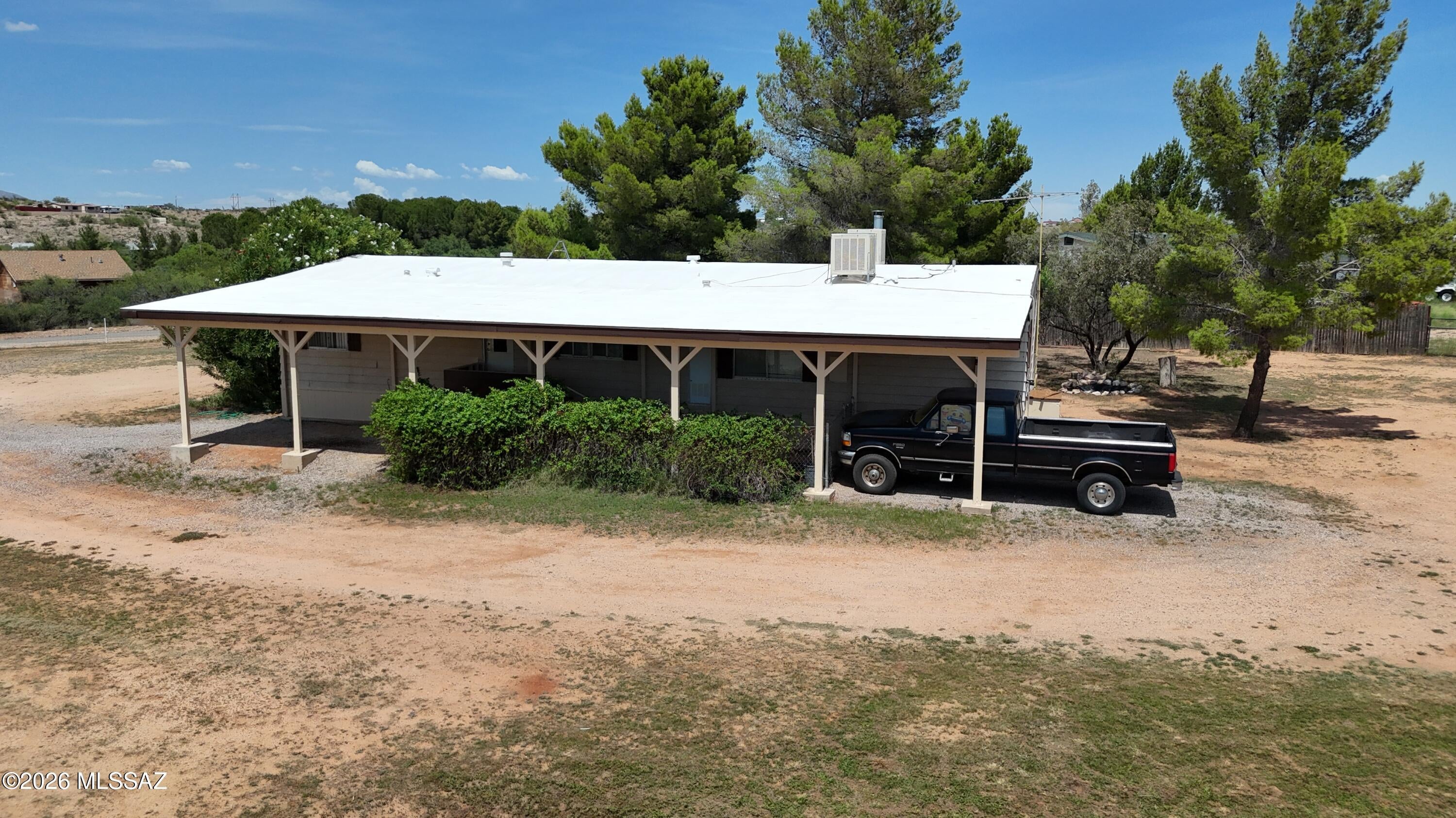 Open space, mountain views, on paved road & so much more!  This lightly lived in 1,680 sq. Ft. 3 bed/2bath Manufactured home sits on over an acre, on a corner lot in the popular J-6 Ranchettes.  The primary bath has a garden tub. Completely fenced to keep your pets/animals secure w/room for them to roam. Zoned for horses.  Small, separately fenced dog run under the carport off the back. Large, covered front deck is great to relax & take in the mountain views. Two spacious sheds.  One has a workshop , or could be a great art studio or craft/hobby room.  The other shed houses the well system w/ plenty of room for additional storage.  Private well located on the property w/a 2-way share. New well pump, pressure switch & pressure tank installed in 2021.  Roof power washed & recoated i