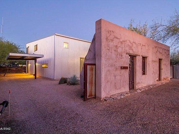 Stunning LOFT Home in Barrio Metalico designed by Architect Rob Paulus built in 2004  - great location for downtown and UofA!  2 bedrooms & 2 full baths, with a remarkable feeling of spaciousness created by 15-foot high ceilings and open loft, large enough to serve as Master Bedroom en suite, with Office space and walk-in closet. Stair, Balcony & railings are exposed steel, flooring is polished integral-color concrete downstairs. Downstairs kitchen w/stainless steel appliances, brand new LG convection oven, maple cabinetry, and exposed steel bar.  First floor Private bedroom & full bath + laundry.  Exterior is sleek metal w/Galvalume finish, energy efficient R-48 insulated walls, and rain harvesting silo. Private courtyard w/natural desert landscaping & shade trees.