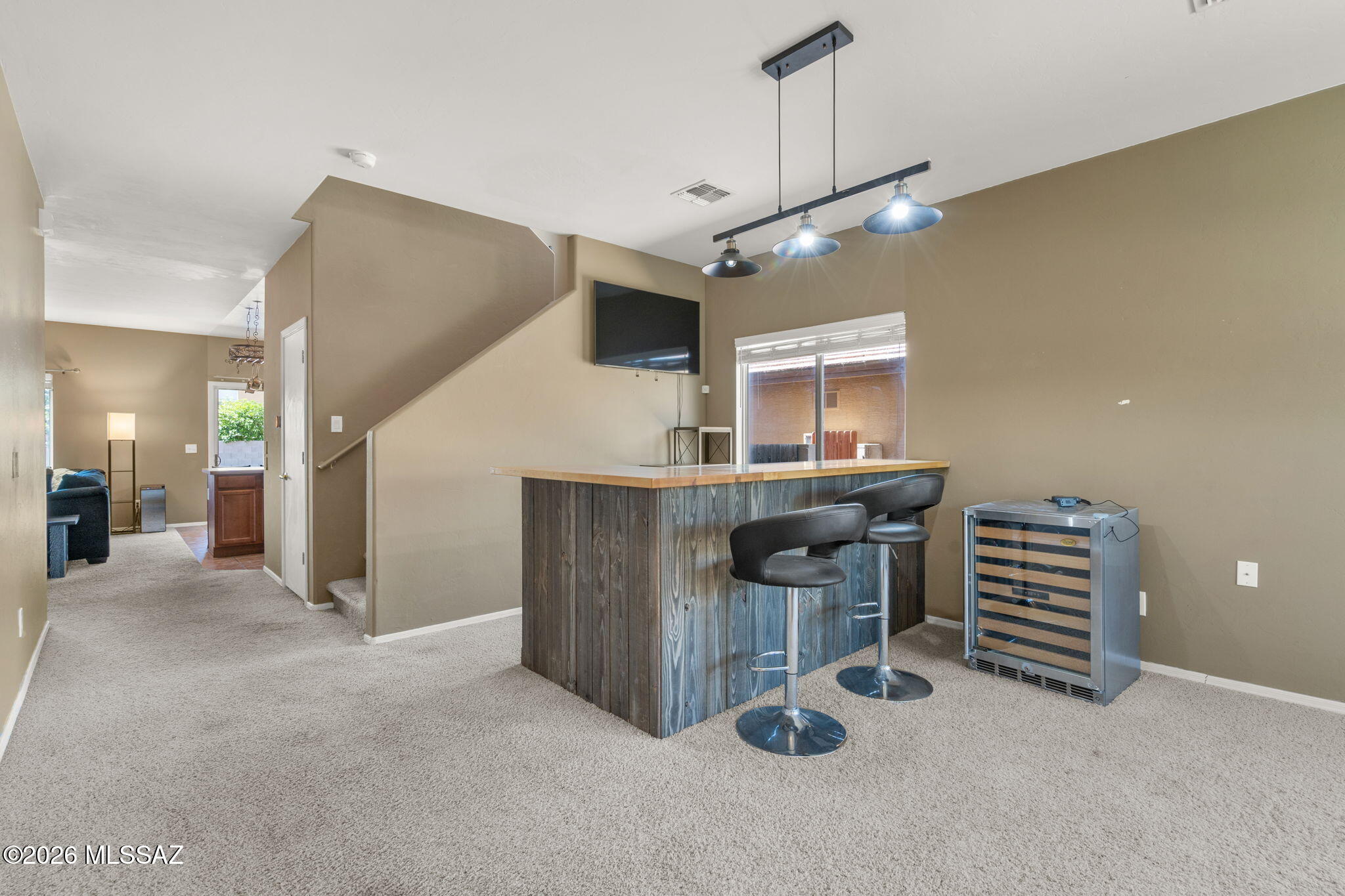 Mountain views, flexible living space, and room to spread out! This spacious 2,317 sq ft home offers a versatile floor plan designed for everyday living and entertaining. The main level features two generous living areas, a well-appointed kitchen, and a flexible den/office that can easily serve as a fourth bedroom. Upstairs, unwind in the oversized loft or retreat to the primary suite and take in the beautiful mountain views. Two additional bedrooms, a full bath, and conveniently located laundry complete the upper level. Recent improvements include a newer upstairs A/C, newer water heater, and re-felted tile roof, offering added peace of mind. With abundant living space, flexible rooms, and mountain views from upstairs, this home offers a lot of lifestyle for the price!