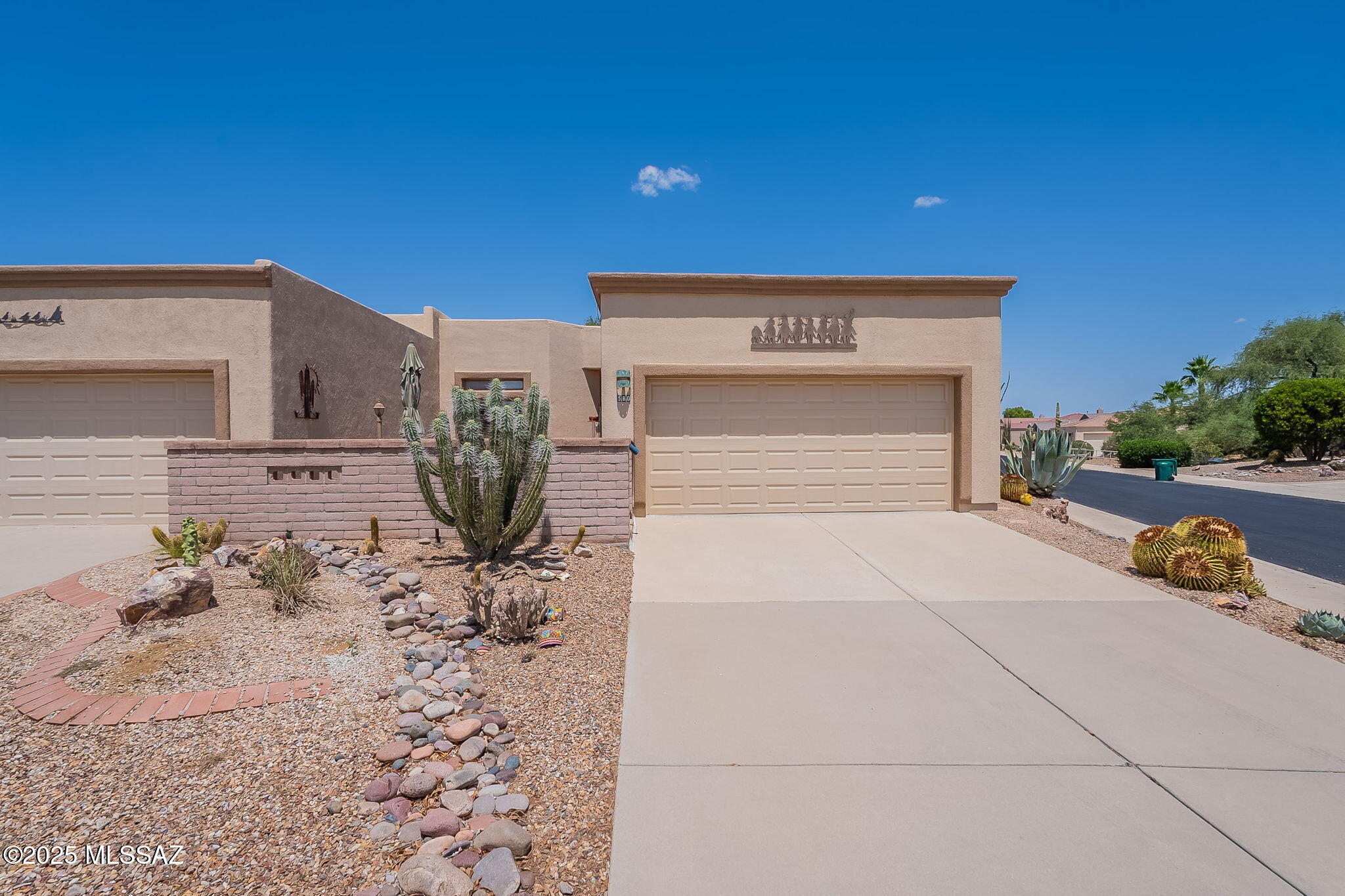 FURNISHED & MOVE-IN READY! Tucked inside a friendly gated community, this beautifully maintained end-unit townhouse makes it easy to arrive, unpack, and start enjoying the Green Valley lifestyle. The community pool is just a short stroll away, while a private enclosed front courtyard welcomes you home. Inside, the inviting great room features a cozy gas fireplace, newer skylights that bring in abundant natural light, and attractive tile-plank flooring throughout the main living areas. Freshly cleaned carpet adds comfort to the bedrooms, while a spacious den provides flexibility for a home office, hobby room, or additional sitting area. The kitchen features stainless steel appliances and convenient pull-out shelving for easy organization and 2 pantry closets for extra storage . Step outside to the enclosed screened patio, a peaceful place to enjoy Arizona's beautiful weather while backing to a shaded wash with no homes directly behind. Everything you need is already here! The garage includes a newer Whirlpool washer and dryer, soft water system, built-in cabinets with workbench, and a second refrigerator--all included. Important updates include a newer garage door and opener, and an HVAC system with limited use due to seasonal occupancy. Fully furnished, lovingly cared for, and truly turnkey--just bring your suitcase and start enjoying your Green Valley retreat! Plus, enjoy access to Green Valley Recreation (GVR), offering pools, fitness centers, clubs, classes, social activities, and countless opportunities to stay active and connected.