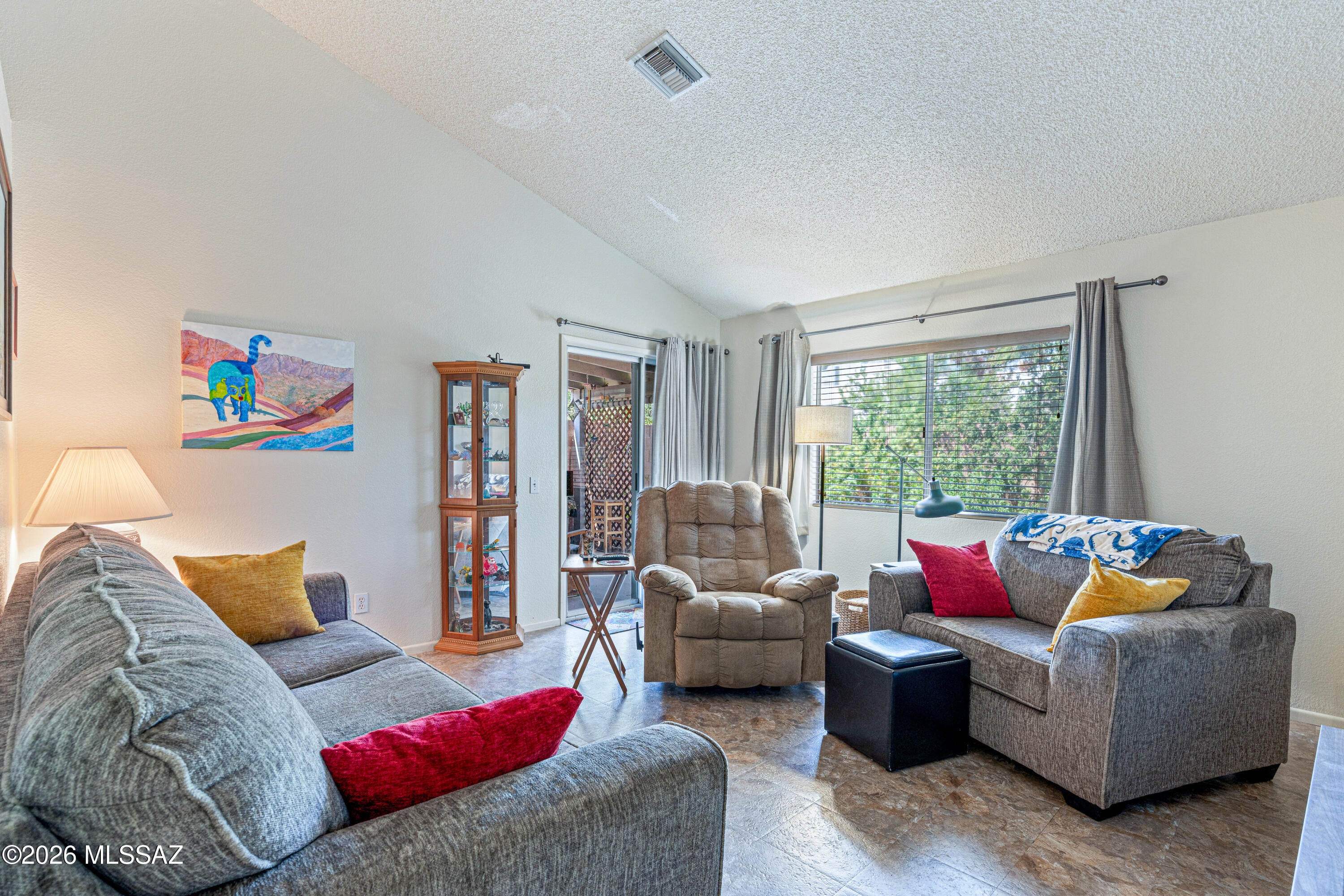 Pride of ownership shows throughout this Star Trails Estates home, lovingly maintained by the same owner for 30+ years. This 3-bedroom, 2-bath home offers 1,174 sq. ft. per assessor, vaulted ceilings, no carpet, interior laundry and no polybutylene plumbing. Enjoy an easy-care backyard with covered patio, plus an interior lot bordered by common area on two sides. The 2-car garage-style carport adds convenient covered parking. Just a short walk to the neighborhood pool, basketball court, playground, ramada and picnic areas. Low HOA fees include sewer, trash, common-area care and road maintenance. Convenient Northwest Tucson location near OMNI Tucson National, Pima Community College, shopping, dining and entertainment.Ideal for full-time living, downsizing or a lock-and-leave lifestyle.