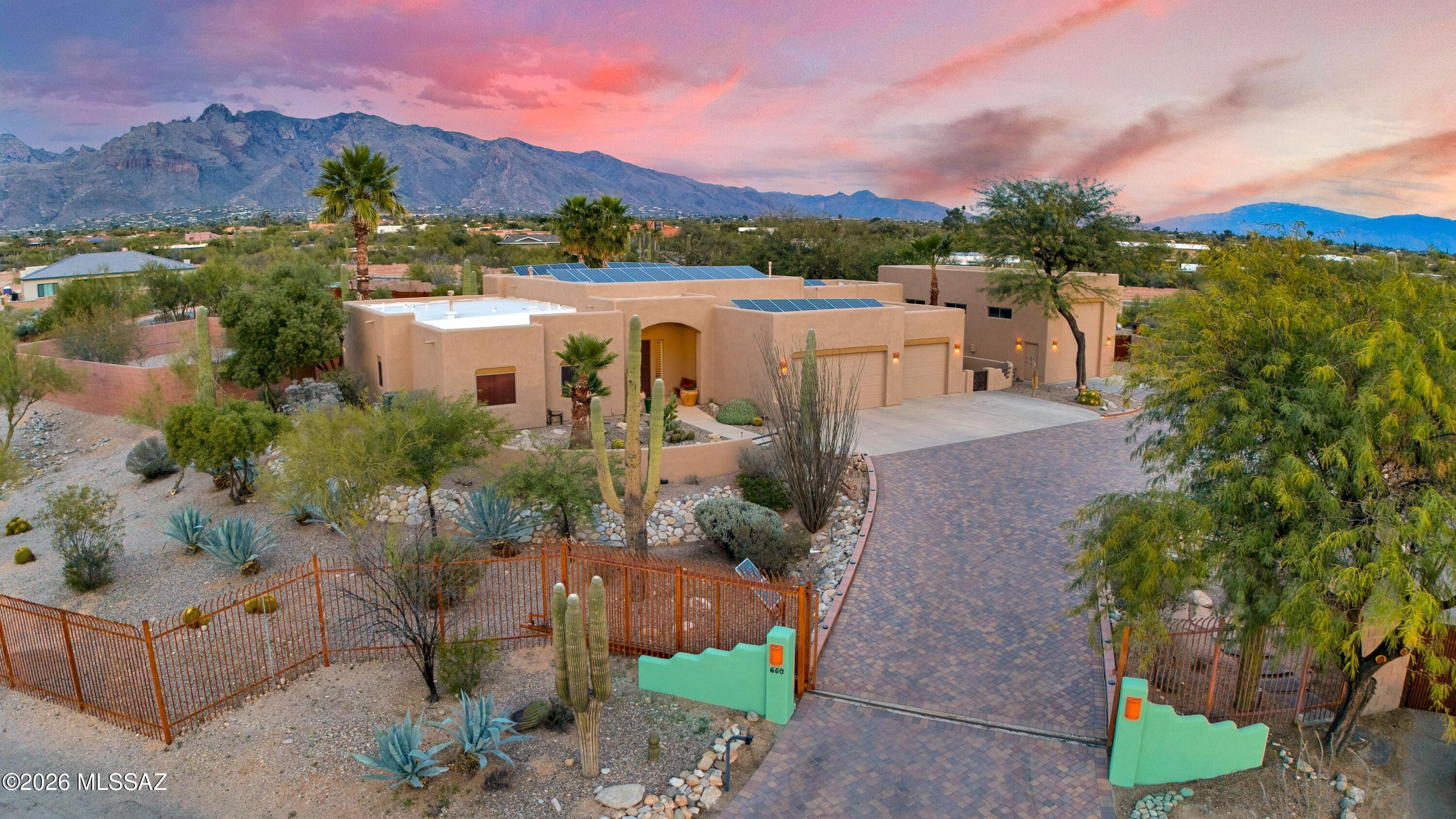ONE OF A KIND! This gated hilltop property offers a unique combination of privacy, security, & stunning, unobstructed mountain views. The original owners have constantly improved this home , adding 37 owned solar panels, a 45'x 20' RV garage with a 14' door, walled & gated RV parking with full hookups, & massive driveway comprised of 26,000 commercial grade pavers. This 1.18 acre property is surrounded by block walls & wrought iron fence with solar operated entry gate. The HUGE home office has a separate entry, courtyard, alarm & A/C with built-in desks, cabinets, lateral files & bookshelves which could be removed to convert back to a guest suite. The Great Room has 14' ceilings, with log viga beams and 8' windows to maximize the views. Look at the rest, then visit the BEST!  OWNER/AGENT