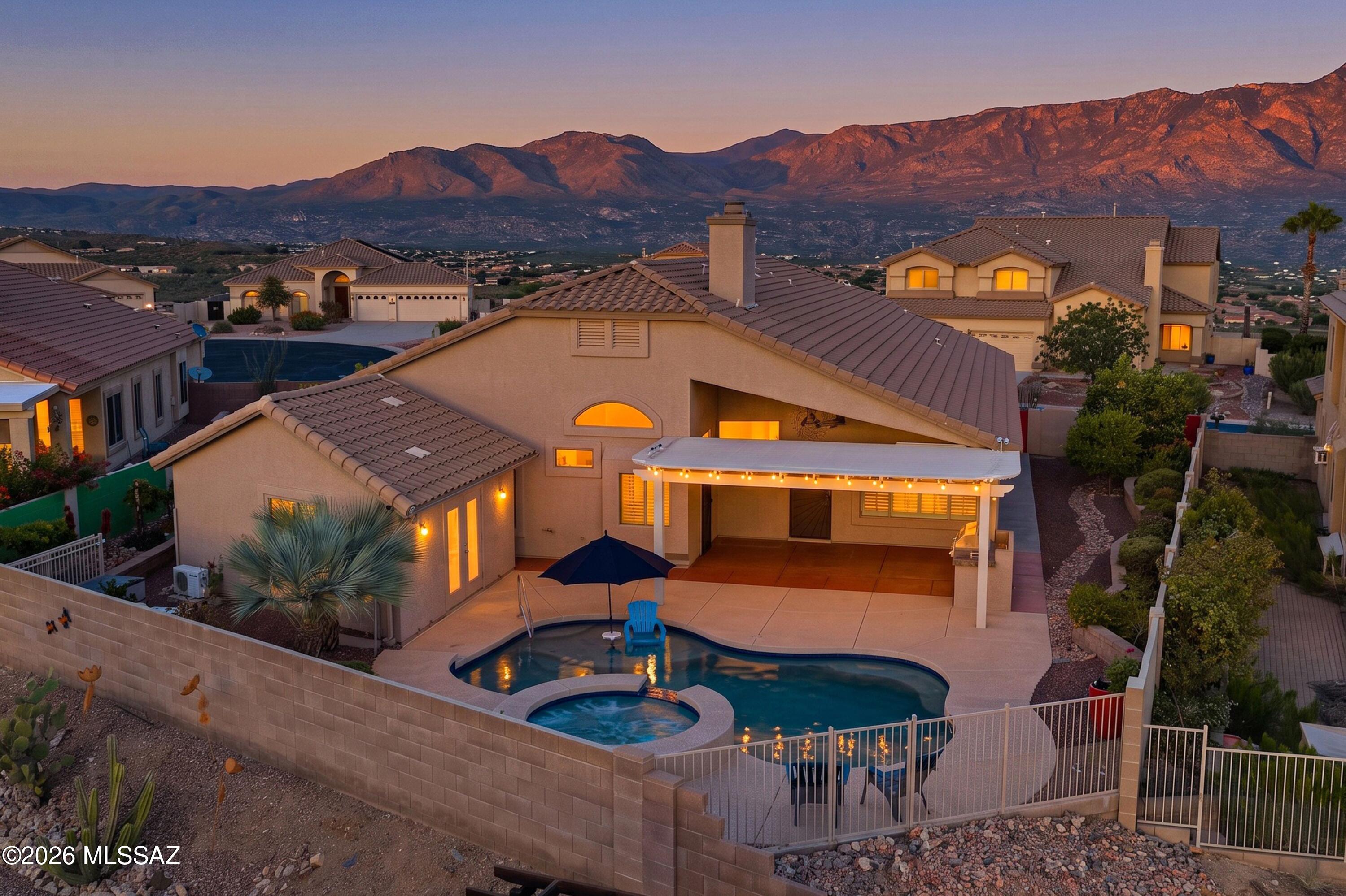 Stunning single-story hilltop retreat featuring breathtaking city, mountain, and sunset views. Beautifully maintained and updated, this 4-bed + den, 3.5-bath residence includes Eagle Crest's only detached, fully furnished guesthouse-perfect for guests or multi-generation living. The main home boasts an updated kitchen with a large island, remodeled baths, a luxurious owner's suite with a custom walk-in closet big enough to dance in, stylish flooring and brand new carpet. Outside, enjoy a resort-style oasis complete with a pool, elevated spa with soothing spillway, outdoor kitchen under a pergola with built-in BBQ, and lush gardens with 7 citrus trees, grapevines, and veggie+herb garden. Fresh paint and newer HVAC! The most unique property Eagle Crest Ranch has to offer!