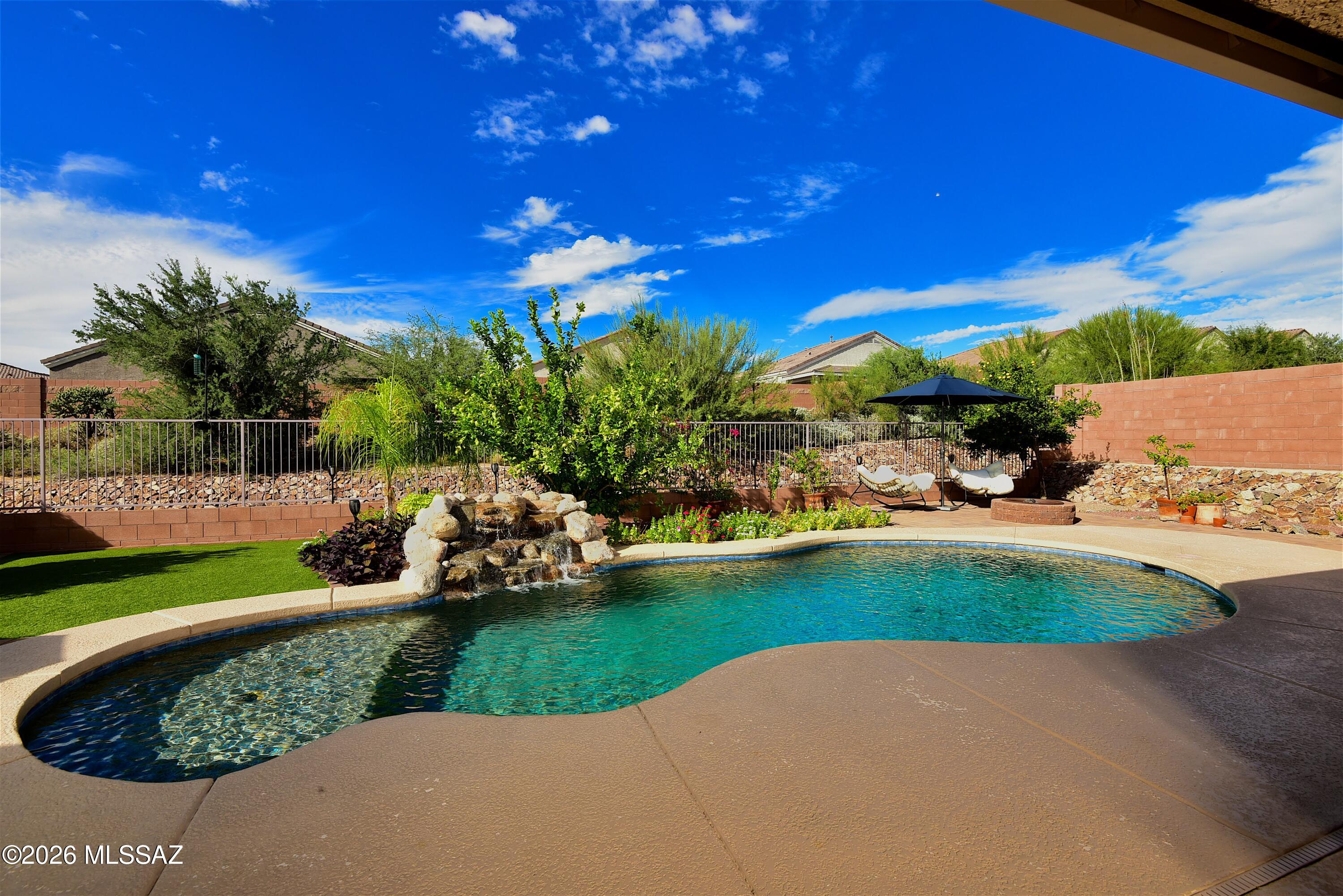 A Spectacular Home in Tortolita Reserve, this 4 -bedroom 3-bath home plus Den/ office features a great room, a dining area overlooking the pool, and a gourmet kitchen with Stainless Steel appliances, a convection cooktop and oven, a microwave, a walk-in pantry, ample cabinet space and a sit up bar. The primary suite features pool views, natural light, sliding glass door access, and executive height vanities, separate tub and shower and a large walk-in closet. The home features a split bedroom concept with 2 guest bedrooms and a full bath with double vanities. The attached guest quarters include a private entrance, kitchen, bedroom, sitting area with an electric wall fireplace, full bath, laundry closet, a 1 car garage and a dedicated walkway to backyard. The resort-style backyard features a fire pit artificial turf, covered patio and outdoor seating areas. The property also includes a main 2 car garage and a leased solar system. Don't miss this wonderful home. Call for an appointment today.