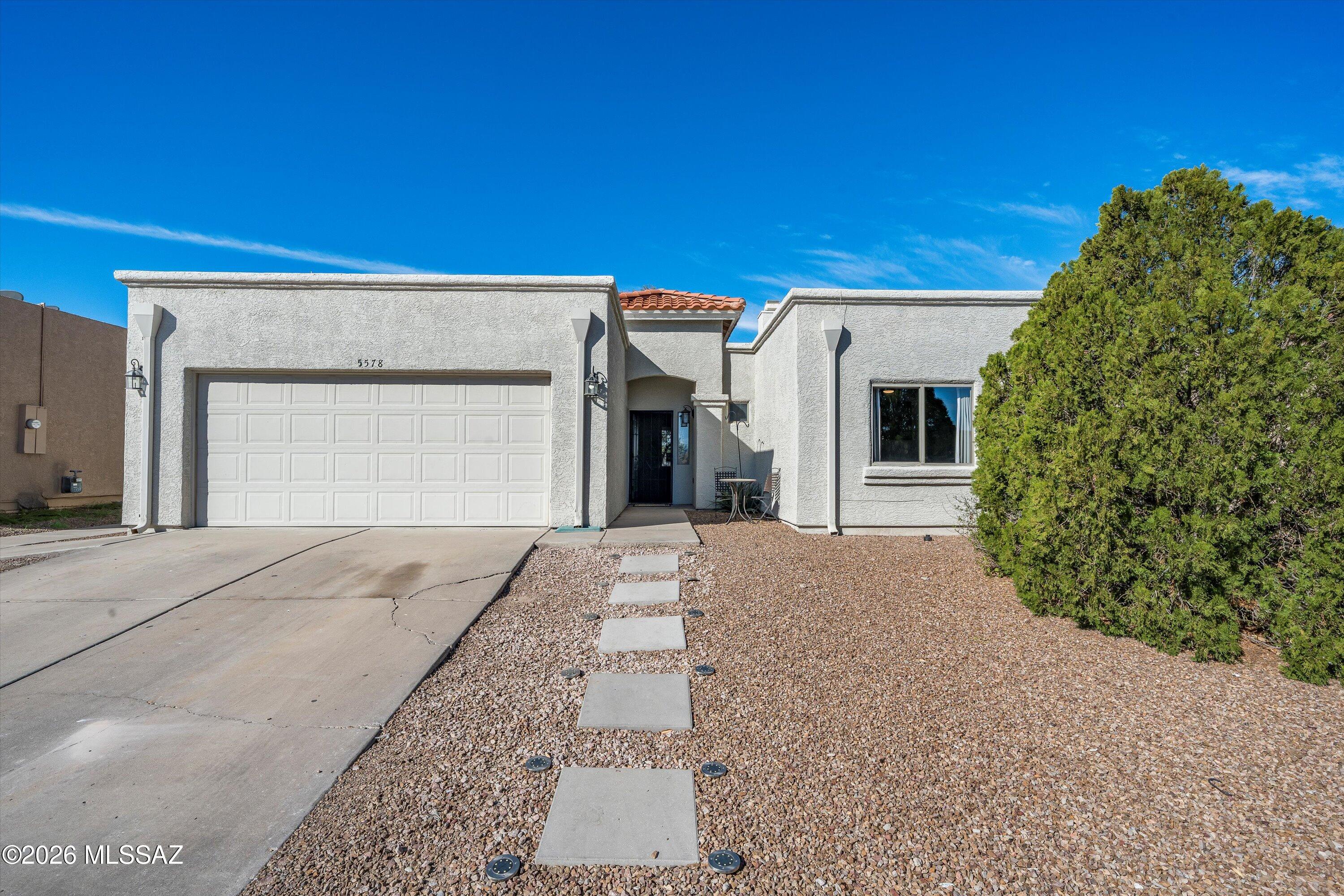 Welcome to this charming 3-bedroom, 2-bath home with 1,517 sq ft in the sought-after Midvale Park community! From the moment you walk in, you'll notice how bright and welcoming it feels, with natural sunlight pouring in and creating an inviting space that instantly feels like home. Step into the expansive great room, where beautiful ceramic tile flooring runs throughout the main living areas, offering both style and easy maintenance. The updated kitchen is a true highlight, featuring granite countertops with a sleek waterfall edge, stainless steel appliances, and plenty of space to cook, gather, and enjoy everyday living. The primary suite is spacious and comfortable, complete with laminate flooring, a large walk-in closet, and an ensuite bathroom with dual vanities and a beautifully tiled walk-in shower. The two additional bedrooms offer generously sized step-in closets that provide great storage while keeping the rooms open and functional.

Step outside to a large backyard with a covered patio that spans the length of the home, ideal for entertaining guests or simply relaxing outdoors. With no rear neighbors, you'll enjoy added privacy and peaceful views.This home offers both comfort and convenience, located just minutes from shopping centers, restaurants, grocery stores, and easy access to I-19. This home is truly special! Come see it before it's gone!