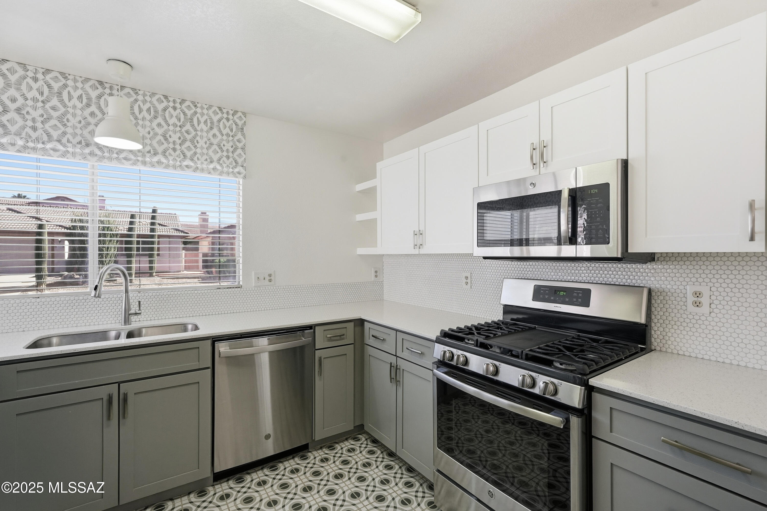 A rare find at $299,000 in Northwest Tucson.  Located in the highly sought-after North Ranch community, this 3-bedroom, 2-bath residence offers vaulted ceilings, an open layout, and seamless indoor-outdoor flow. The kitchen showcases quartz countertops, two-tone cabinetry, and decorative tile, making it functional and inviting.
Cork flooring throughout provides a unique, durable surface and presents a great opportunity for buyers looking to customize flooring to match their personal taste. The primary suite features direct backyard access and a custom California closet. 
Residents enjoy resort-style amenities including pools, tennis and pickleball courts, parks, and scenic walking paths,