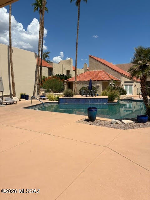 Northside great location! 2 bdrm./2 ba upstairs condo with a split bedroom floor plan. Enjoy the very spacious great room with fireplace, valuted ceiling, clerestory windows and patio french doors to enjoy the mountain views. One covered parking space with the community offering a pool, spa and fitness center. Only minutes to Trader Joes, Rillito Riverwalk, St. Phillips Plaza and much more! Water included in HOA fee paid by Owner.