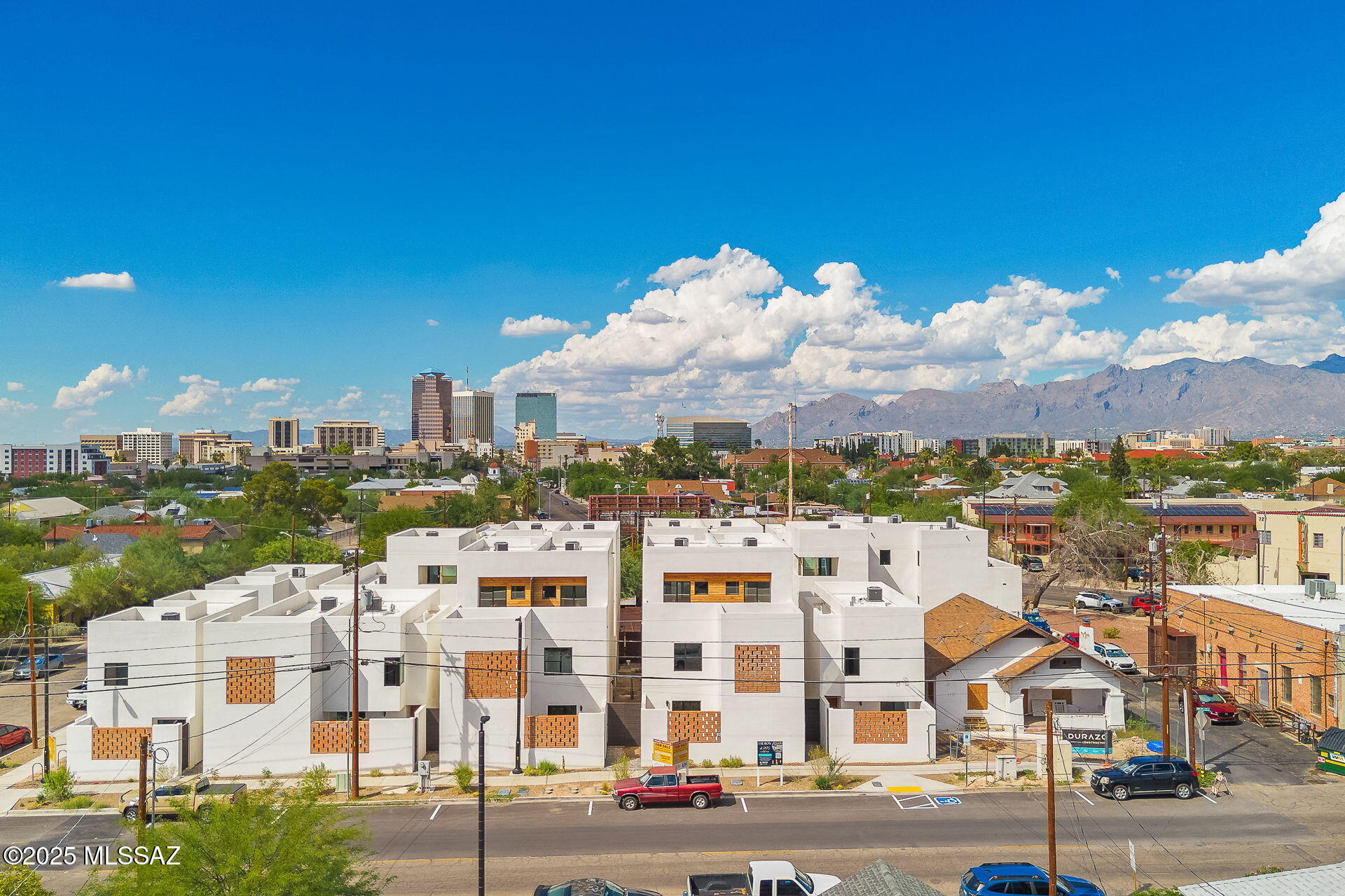 Welcome to the epitome of upscale urban living in Tucson's vibrant Five Points neighborhood, where modern sophistication meets historic charm. This is The Row at 18 W. 18th, an exclusive 16-unit desert contemporary townhome subdivision featuring a harmonious blend of luxury & location, boasting solid white, smooth stucco construction with authentic adobe brick accent walls. Meticulously designed by HA|RU architects, in collaboration with Durazo Construction, honors the ethos of Southern Arizona with clean lines and a contemporary feel that maximizes natural light, creating an open, and airy ambiance throughout each home. The kitchens are designed for style and functionality, complemented by custom Davis Kitchen cabinetry that embody superior craftsmanship and luxurious design. The primary bedrooms offer en-suite baths with custom closets by Classy Closets, offering ample storage solutions. These thoughtfully designed spaces are perfect for the discerning homeowner who values quality and attention to detail, captured throughout each space. Located in the heart of vibrant Five Points, where 5 historic and distinct neighborhoods meet, these townhomes offer unrivaled walkability and access to a plethora of amenities and authentic, local restaurants. Residents will enjoy a dynamic lifestyle with everything at their doorstep from artisan coffee shops to organic grocers, eclectic dining, and vibrant community events, all with a Walk Score of 84 and a Bike Score of 98. This is more than a home; it is a lifestyle rooted in convenience, culture, and modern luxury, seamlessly blending with the historical beauty of Tucson. Embrace the opportunity to live in a place where contemporary design and historic charm coexist in perfect harmony.
