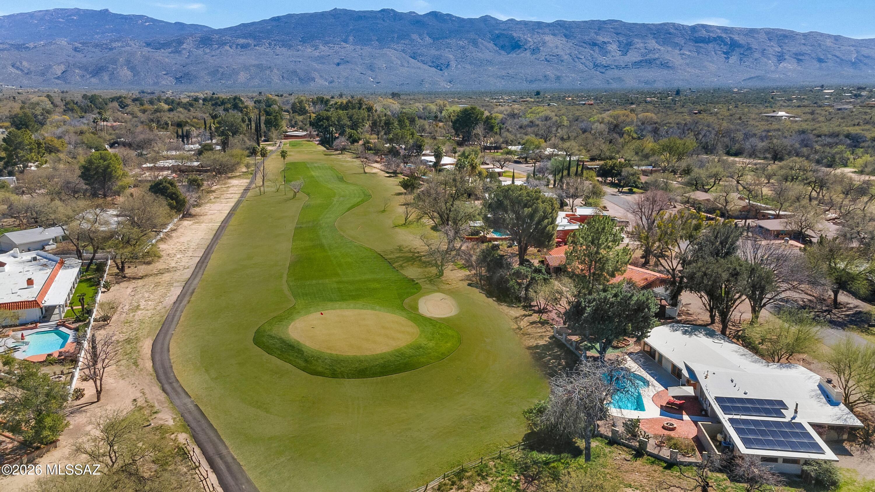 Perfectly positioned on the 16th green in sought after Forty Niner Country Club Estates, this beautifully renovated 3 BR, 3 BA brick home captures both golf course and majestic mountain views. Inside, polished concrete floors and custom birch cabinetry create a refined, modern aesthetic. The one of a kind round kitchen is a true centerpiece, featuring a Thermador oven, Bosch cooktop, stone countertops, and seamless flow into the family room and dining area. Walls of glass and inviting AZ room bring the outdoor living in. Energy efficiency is a major bonus with a Tesla solar system installed in 2024 that will be paid off at closing. Set on .60 acre, the backyard is a private retreat with a sparkling pool and a remarkable collection of mature plantings including blackberry, peach, red & green grapes, grapefruit, lemon, lime, plum, fig, basil, Texas rangers, lantana, and roses. A rare opportunity to own a distinctive, move in ready home on the golf course in one of Northeast Tucson's most desirable communities. 

Convenient location in the Tanque Verde Valley just 10 minutes to grocery stores, restaurants, bars, cafes, & more. Get to Summerhaven at the top of Mt. Lemmon in less than an hour for cooler temperatures in the summer or to play in the snow in the winter. Access to endless hiking, biking, and horseback riding trails in the Catalina and Rincon mountains. Play golf at 49ers Country Club or the acclaimed Arizona National Golf Course just 10 minutes away. La Mariposa Fitness & Sports Club features tennis/Pickleball Courts, workout facilities, a junior Olympic-sized swimming pool, and a variety of fitness classes. Area schools include the highly-rated Tanque Verde School District, This home is located in the highly-rated Tanque Verde School District, which consists of a Tanque Verde (TV) pre-school, Agua Caliente & TV Elementary School, Emily Gray Jr. High School, and TV High School.
Hermosa Montessori School, Leman Academy of Excellence Charter School, Basis Charter, The Gregory School, St. Michael's, St. Cyril's, Desert Christian K-12, the La Paloma Academy, and more.

49ers Country Club:
49ers Country Club is a semi-private club designed by William Francis Bell. Spread over 110 acres, the course is known for its lush, mature landscaping and excellent course conditioning. Members enjoy a 6,681-yard, 18-hole, par 72 golf course. The winding fairways and majestic mountain views surprise golfers at every turn.
The Rincon Mountain Grill, a full-service restaurant open to the public, serves breakfast, lunch, and dinner. Forty Niners CC offers a swim team, summer camps, and several events throughout the year, including holiday parades and other special events. The new fitness training facility is fully equipped gym offering fitness and yoga classes.


Mount Lemmon:
Just an hour away, Mount Lemmon is the highest point in the Santa Catalina Mountains, topping out at more than 9,000 feet. Visit this mountain retreat to cool off in the warmer months and to enjoy a snowy playground in winter. Top cyclists from around the world come here to train on one of the best tests of climbing and descending in the country. There are trails for hiking and biking all over the mountain, and over 2500 rock climbing routes to choose from.