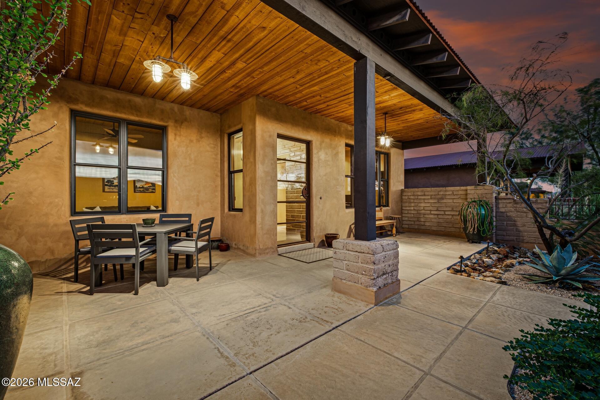 Set against Catalina Mountain views and private open space, this distinctive Stellar Gray-built home in gated SkyRanch showcases exceptional craftsmanship and thoughtful Southwestern design. Rasta Block (ICF) construction, a steel roof and polished concrete floors set the foundation, while hand-plastered walls, cedar-planked ceilings and authentic antique doors add warmth and character. The kitchen features Metropolitan quartz counters, a quartzite island and Thermador and DCS appliances. Outdoors, beautifully designed landscaping, a spacious patio and raised firepit create a private setting for entertaining or unwinding while taking in the mountain views.