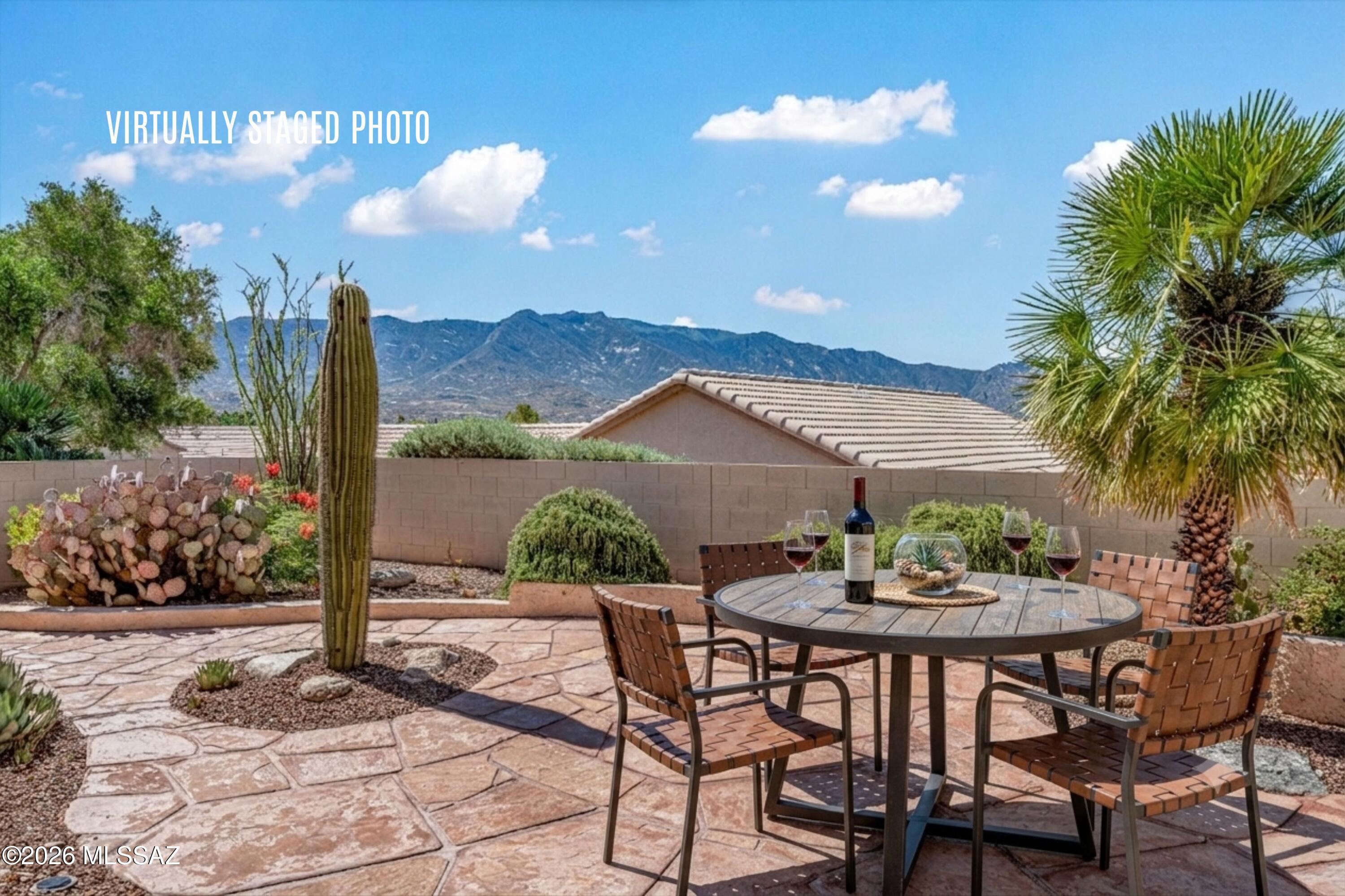 VIEWS! VIEWS! VIEWS! Estancia in the heart of SaddleBrooke -- steps to Clubhouse, resort pools, dining, fitness, pickleball & all of SaddleBrooke's world-class amenities -- this is the move-in ready home buyers dream about. Arrive through a private flagstone front courtyard, then step inside to sweeping Catalina Mountain views from the great room, front bonus room & flagstone backyard patio. Vaulted ceilings with arched architectural details & walls of windows throughout. New roof underlayment Nov 2025 ($19,860 | 5-yr warranty). Fresh interior & garage paint Nov 2025. Granite counters, KitchenAid oven/micro, 2024 gas cooktop & Bosch dishwasher. Beautiful granite in both baths -- remodeled primary marble-look walk-in shower, hex marble floors & custom niches. No carpet! See More... Generous 2,405 SF Estancia floorplan offering 2 bedrooms, 2 beautiful bathrooms, a home office space, a bonus front room; library, sitting room, game room, or secondary TV room for those families that like to watch different shows. The bonus room is one of this home's most compelling features: enormous and airy with soaring ceilings and mountain views framed by generous windows. The private flagstone front courtyard w/ peek-a-boo mountain views sets the tone from the moment you arrive -- a welcoming, low-maintenance outdoor living space that's rare and sought-after in this community. The primary suite offers a genuine retreat, tucked away from main living areas with a remodeled en-suite  marble-look porcelain shower, custom bench, corner niche, and hexagonal marble tile floor.
Wood-look laminate flooring in both bedrooms. Tile floors in main living areas and primary suite. Pull-out shelving throughout kitchen cabinetry. Garage storage cabinets.

* Roof underlayment replaced November 2025 -- $19,860 investment, 5-year warranty
* Interior & garage paint November 2025
* Gas cooktop replaced 2024
* Water heater manufactured October 2020

The backyard is a professionally landscaped desert oasis -- flagstone patio, saguaro, colorful blooms, a graceful palm, raised planters, and a lighted stepped stucco wall, all framing those signature Catalina Mountain views. Morning coffee out here sells the home.
Vacant, soft-staged, and ready to show beautifully.