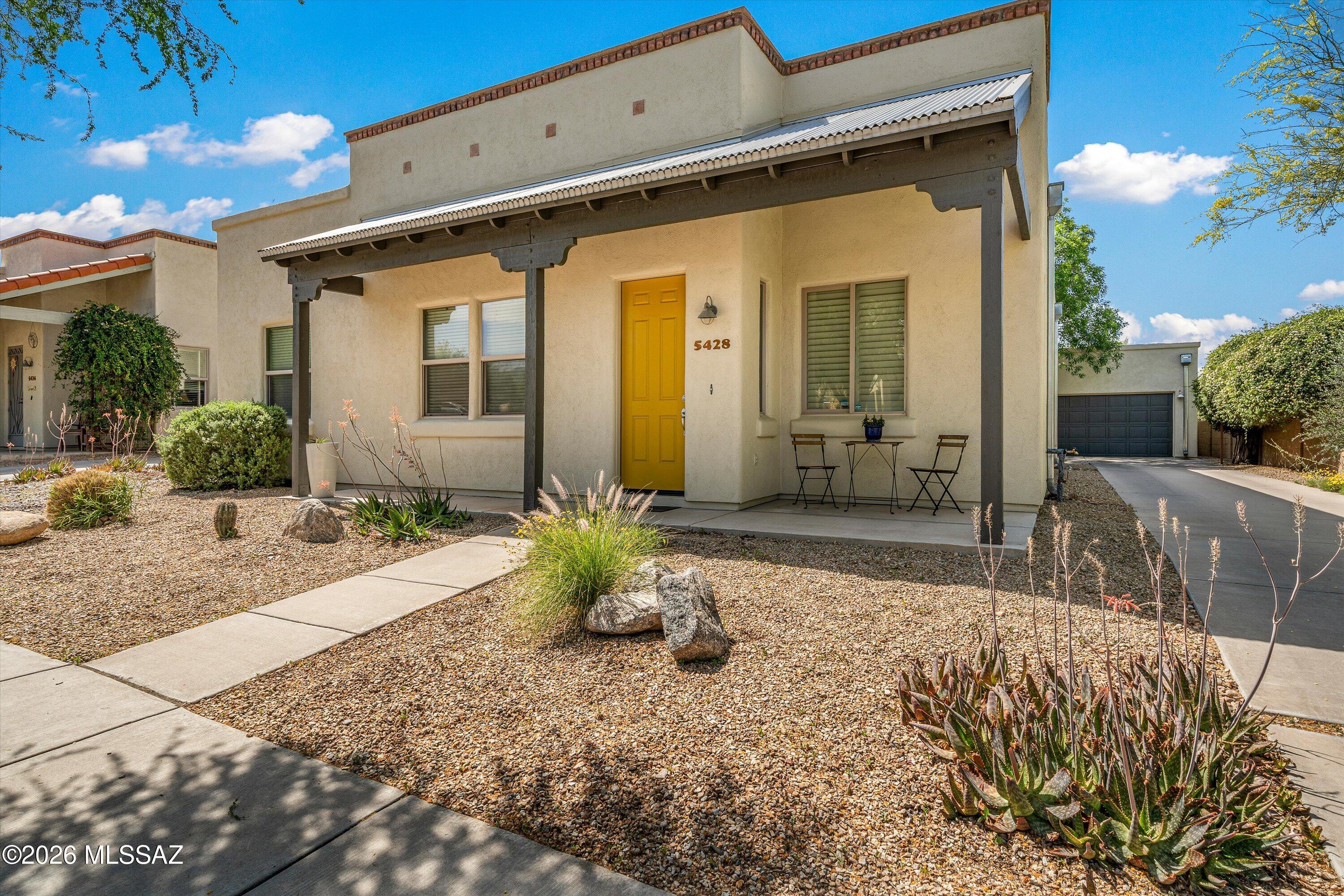 This beautifully maintained 4-bedroom home in the desirable community of Civano offers a spacious and functional layout with high-end finishes throughout. Enjoy 10-foot ceilings, plantation shutters, and an abundance of natural light that enhances the home's open feel. Real wood flooring adds warmth to the living room and master suite, while colored concrete flooring offers easy care in the additional bedrooms. The large kitchen is perfect for entertaining with granite countertops, built-in desk and ample storage, and a new refrigerator. Roof coated in April, 2026.

Step outside to a covered patio overlooking a large backyard with mature citrus and shade trees. This private lot backs up to a peaceful desert green space with no rear neighbors. The custom welded wire fence adds both character and security. The detached 2-car garage offers extended space for storage and hobbies. Major upgrades provide peace of mind, including a new HVAC system (2023), solar/electric water heater (2020), and exterior paint (2022).
Located in Civano, this home is part of a thoughtfully designed community centered on connection to nature and neighbors alike. You will enjoy two solar-heated pools, tennis and pickleball courts, a sports field, basketball court, and a community garden.  Connect with neighbors at the Community Center, monthly food truck round-up or one of the neighborhood businesses. Multi-use trails bring nature to your doorstep.
