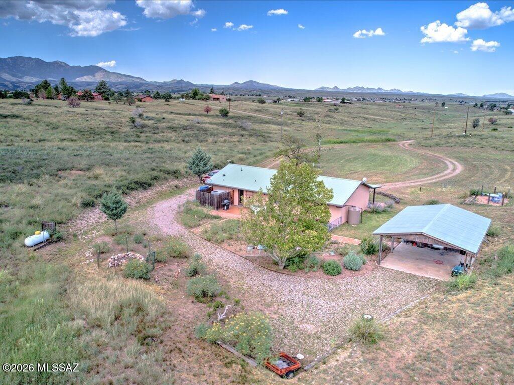 Adorable Ranch home with End of road privacy! Desirable location in Los Encinos w/OWNER Financing possibility! 2/3 of home Leased out @ $1800 per mo thru 3/31/27 this is a Split Bdrm floor plan (Owner occupies primary Bdrm w/private entry & use of land) Home sited toward back of property for privacy  allows plenty of usable space to add a shop/barn etc. Includes a Cov'd 20x22' carport w/walk-in storage, circular drive, a lovely back yard & low care landscaping with a nice size front Cov'd patio. A cozy living room/kitchen combo w/saltillo tile flooring, custom wood barn style cabinetry, Lrg carved wood kitchen breakfast bar w/concrete top. All appliances incl. Upgraded walk-in tile shower & built-ins in Bdrm! Furnishings Negotiable! This property has the charm of small town Sonoita living!