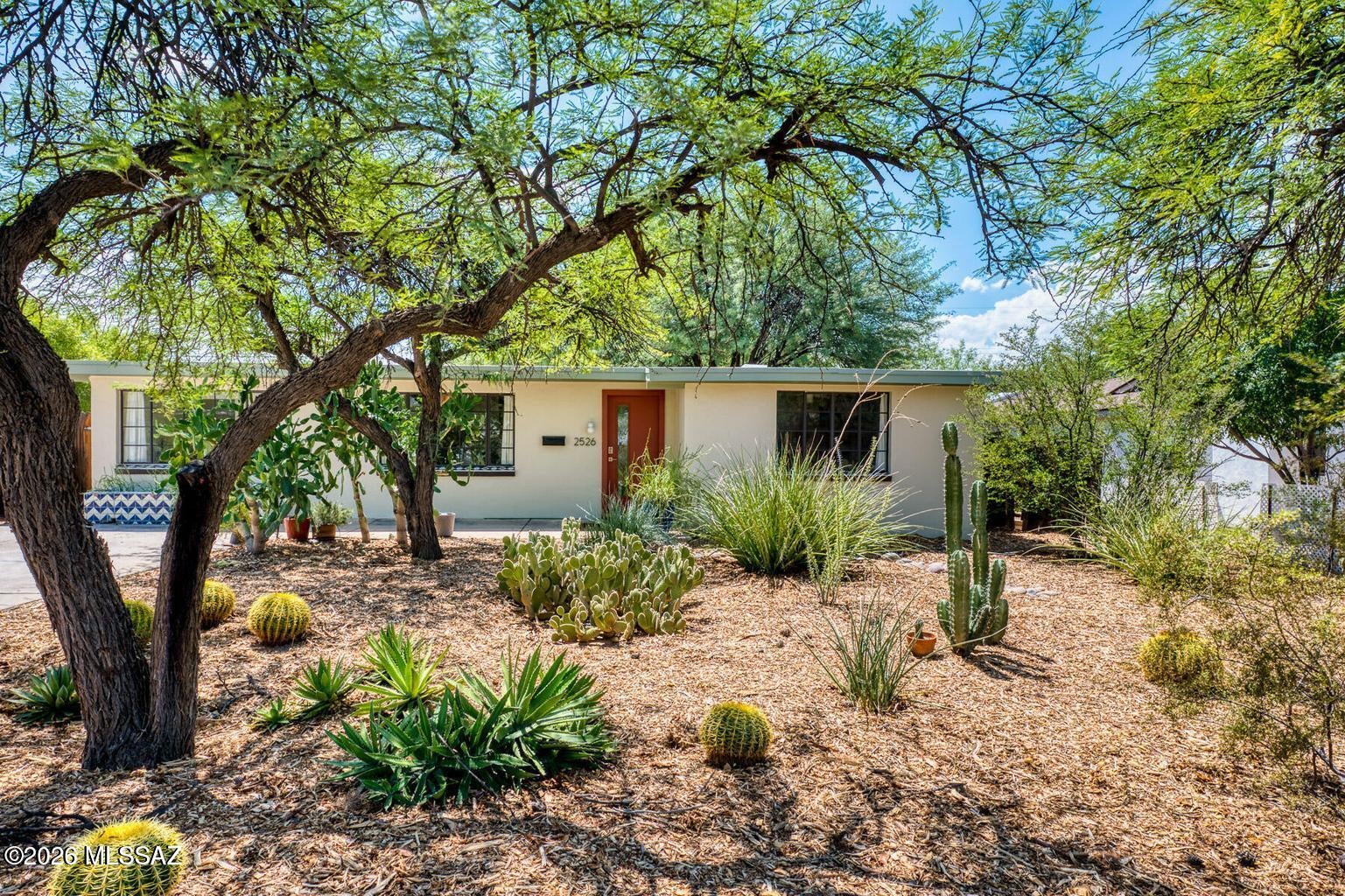 Thoughtfully updated midcentury home in Tucson's historic Blenman-Elm neighborhood, combining original character with an uncommonly functional indoor-outdoor plan. A contributing property in the Blenman-Elm National Register Historic District, the home retains original steel casement windows and warm wood ceilings alongside a renovated kitchen and baths. Living and dining spaces connect directly to a shaded patio and backyard with mature shade trees. Three light-filled bedrooms, vintage built-ins, and a fireplace add character and function. The generous 69' x 131' R-1 lot offers unusual flexibility under Tucson's new middle-housing rules. Near the University of Arizona, Banner, and Himmel Park, with Postino and Snooze just blocks away.