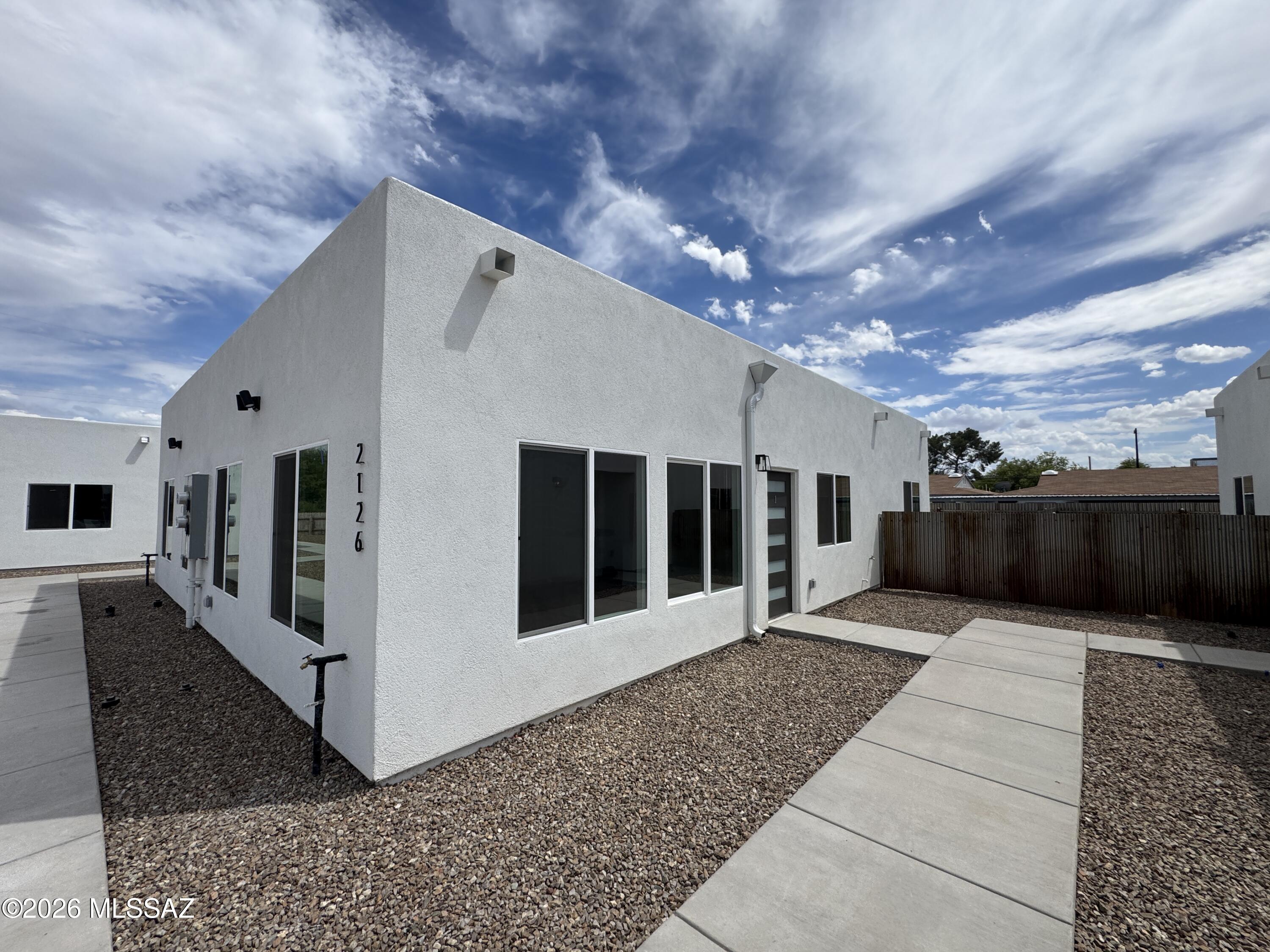 Welcome home to this newly built, thoughtfully designed duplex in Tucson! This unique 1-bedroom, 1-bath residence offers a bright and spacious open-concept living and dining area, perfect for both relaxing and entertaining. The modern kitchen features sleek finishes, ample cabinetry, and convenient bar seating for casual meals or hosting guests. Enjoy the ease of in-unit laundry and retreat to a generously sized primary suite designed for comfort and privacy. With contemporary style, efficient layout, and a fresh, modern feel throughout, this home is ideal for those seeking low-maintenance living in a prime Tucson location near shopping, dining, and everyday conveniences.