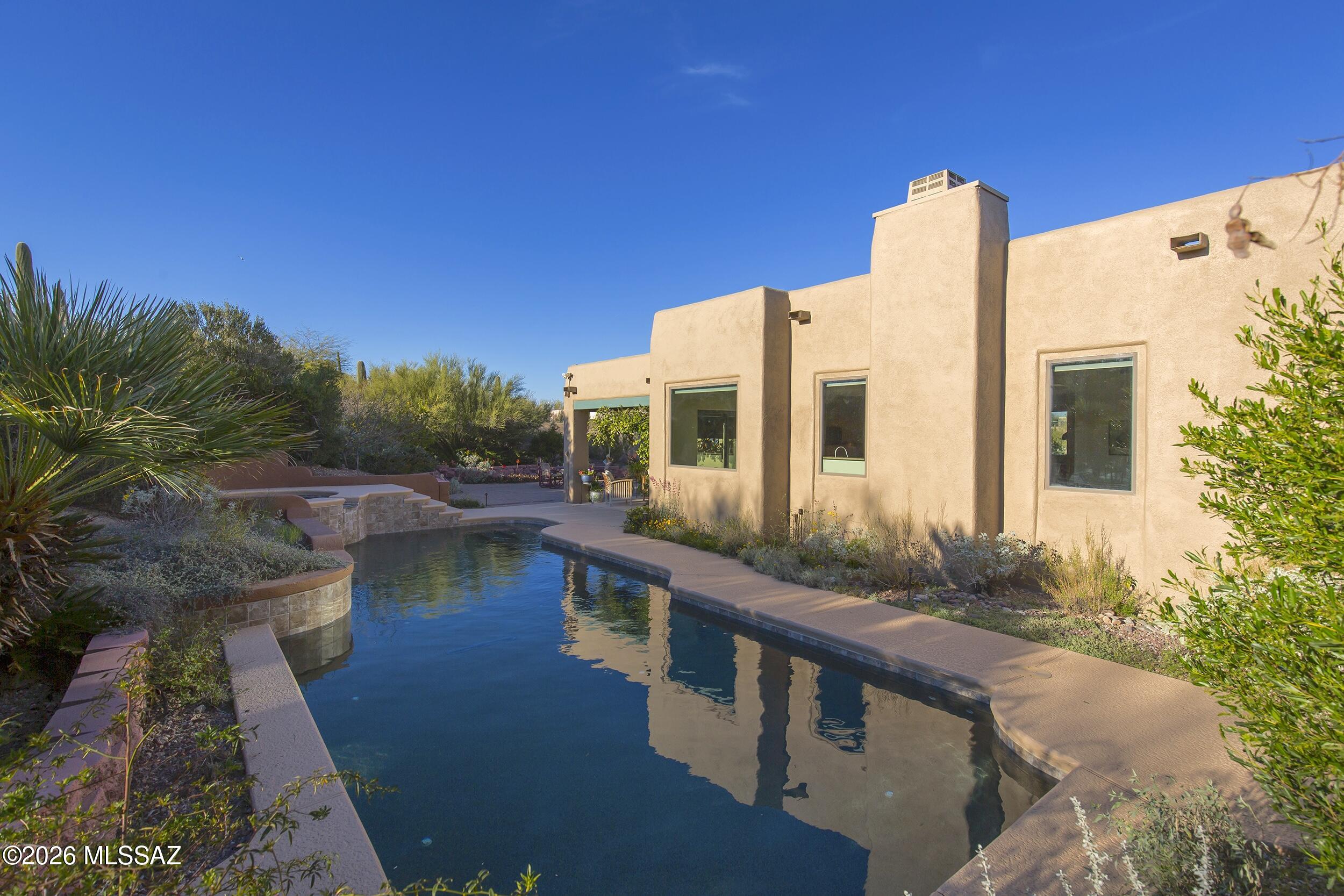 Welcome to your private desert retreat in the heart of the Tucson Mountains; the kind of property buyers wait for yet rarely find. This home captures unobstructed views of the Catalina Mountains while delivering the perfect blend of comfort, style and peace of mind. With 3 bedrooms and 2 baths, the split layout is both functional and inviting. Wood-grain italian porcelain tile floors flow seamlessly throughout the main living areas, offering warmth and durability to satisfy today's lifestyle demands. The updated kitchen is thoughtfully designed with modern finishes and easy flow into the living and dining areas, making it ideal for both everyday living and entertaining. Step outside, through the hanging vines in the covered patio, to the sprawling brick patio with pool and spa, to discover your own oasis. Whether you are hosting sunset gatherings or enjoying a quiet morning swim, this space is designed to embrace the Arizona lifestyle year round. Lush desert vegetation surrounds the property, providing beauty, privacy and habitat for bird watching. Major updates provide confidence and value, including a new roof, newer HVAC unit, new pool filter and newer "mini pebble" pool and spa liners. This is more than a home. It is a serene desert sanctuary with breathtaking Catalina views, modern upgrades, and a backyard built for memories.
