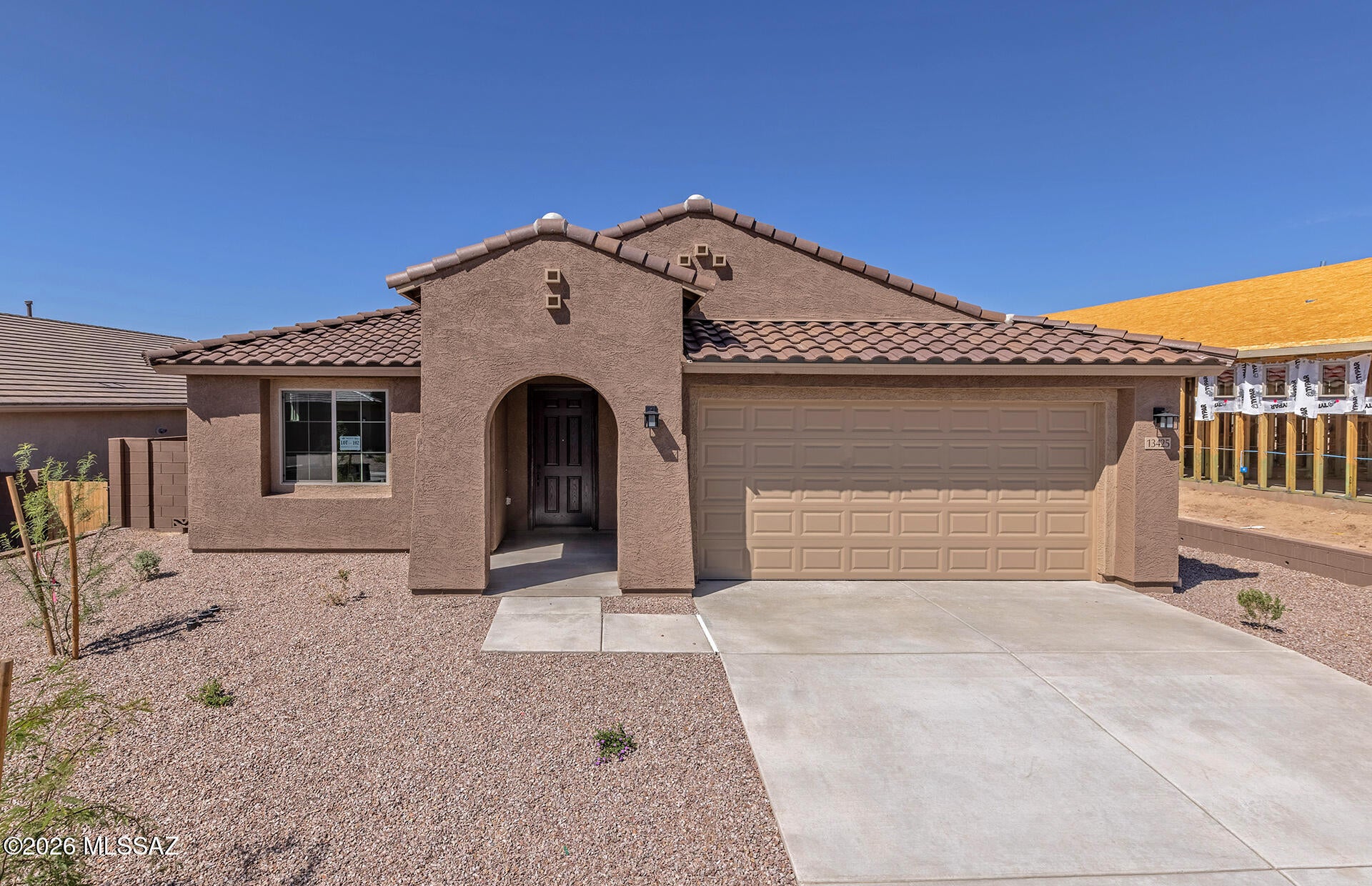 This residence features a desirable split floor plan with a Spanish-style exterior. The kitchen offers a chef-inspired layout with a gas cooktop, stainless steel Whirlpool appliances, upgraded Spirit Maple Café cabinets, Gem Stone Beige quartz countertops, and a custom backsplash.
The quartz selections in the kitchen are also featured in the owner's bath and Bath 2. Additional upgrades include 12x24 Advantage Artiquity tile installed in a straight-stack pattern. Energy-efficient features include a tankless water heater, low-flush toilets, low-flow showerheads, dual-pane Low-E windows, and more.