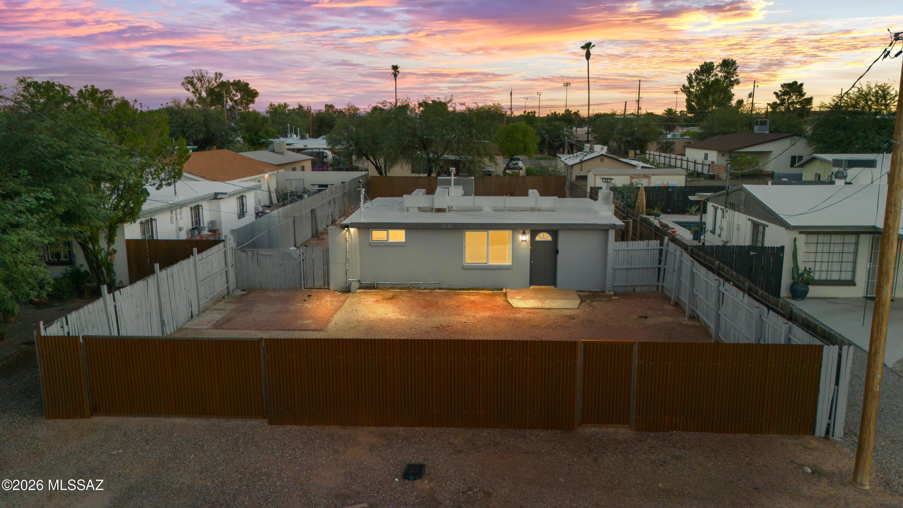 Welcome to 3236 E Bermuda Street! This updated Tucson home sits on a large, fully fenced lot with plenty of room to enjoy the outdoors. Inside, you'll find an open living space with exposed beam ceilings, wood-look tile flooring and a brick fireplace. The updated kitchen features white cabinetry, solid-surface countertops, stainless steel appliances and a gas range. The bathroom has also been updated with a tiled tub/shower surround, and indoor laundry adds convenience. Outside, the spacious yard offers plenty of room for entertaining, pets, gardening, additional parking and more. Move-in ready with an updated interior and outdoor space that's hard to find in the middle of Tucson!

Professionally prepared plans for a proposed 437 SF 1-bed/1-bath detached ADU included. Buyer to verify.