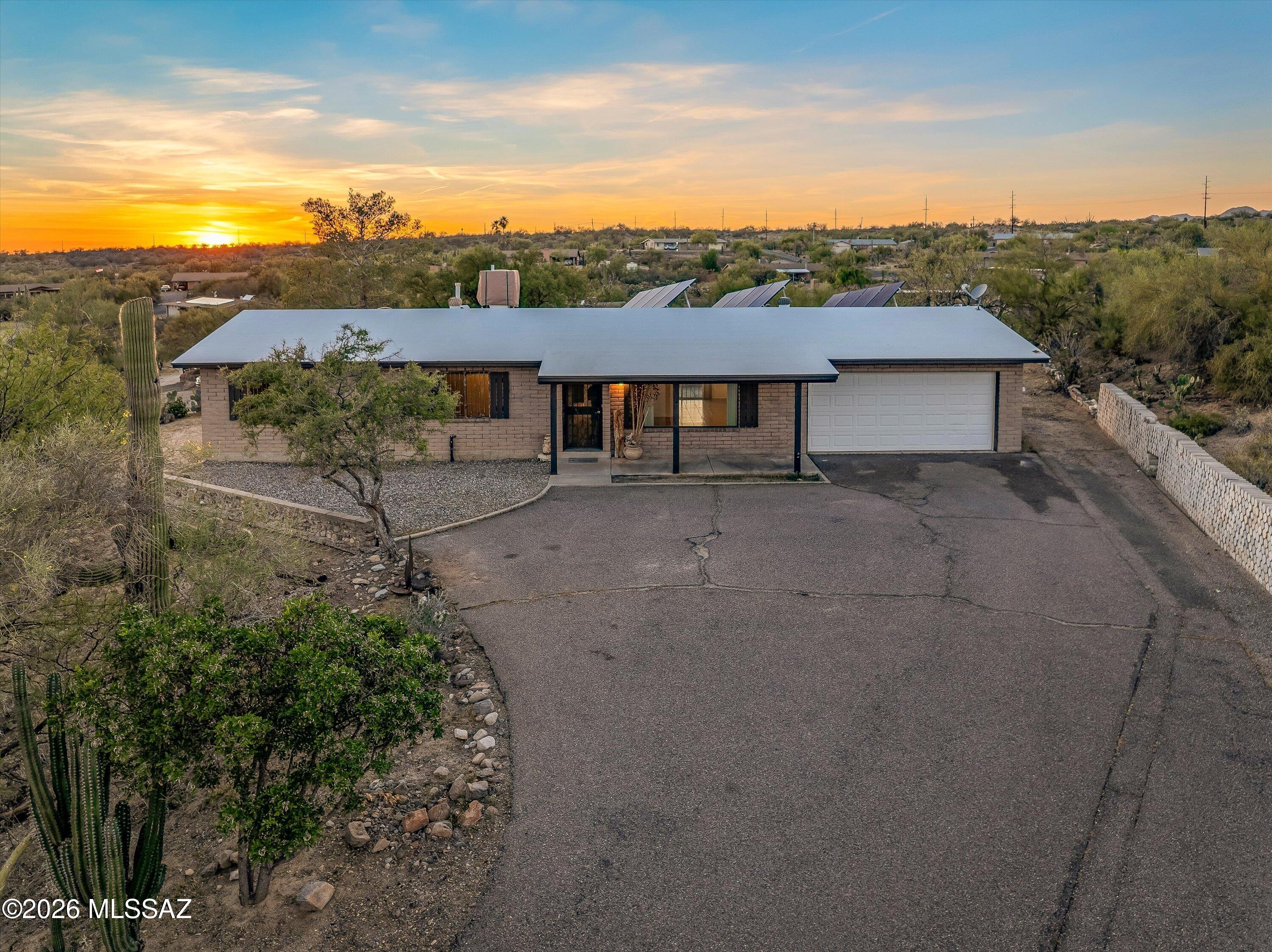Perched on a hilltop at the end of a quiet cul-de-sac, this 3-bedroom, 2-bath home offers breathtaking, million-dollar mountain views on over 1.17 acres. Located in the desirable Oro Valley area, this 1,296 sq ft residence is filled with natural light, creating a bright and inviting atmosphere throughout. Enjoy added privacy,  outdoor space, and the benefits of owned solar for energy efficiency. A rare opportunity to own a scenic view property with room to make it your own with no HOA.