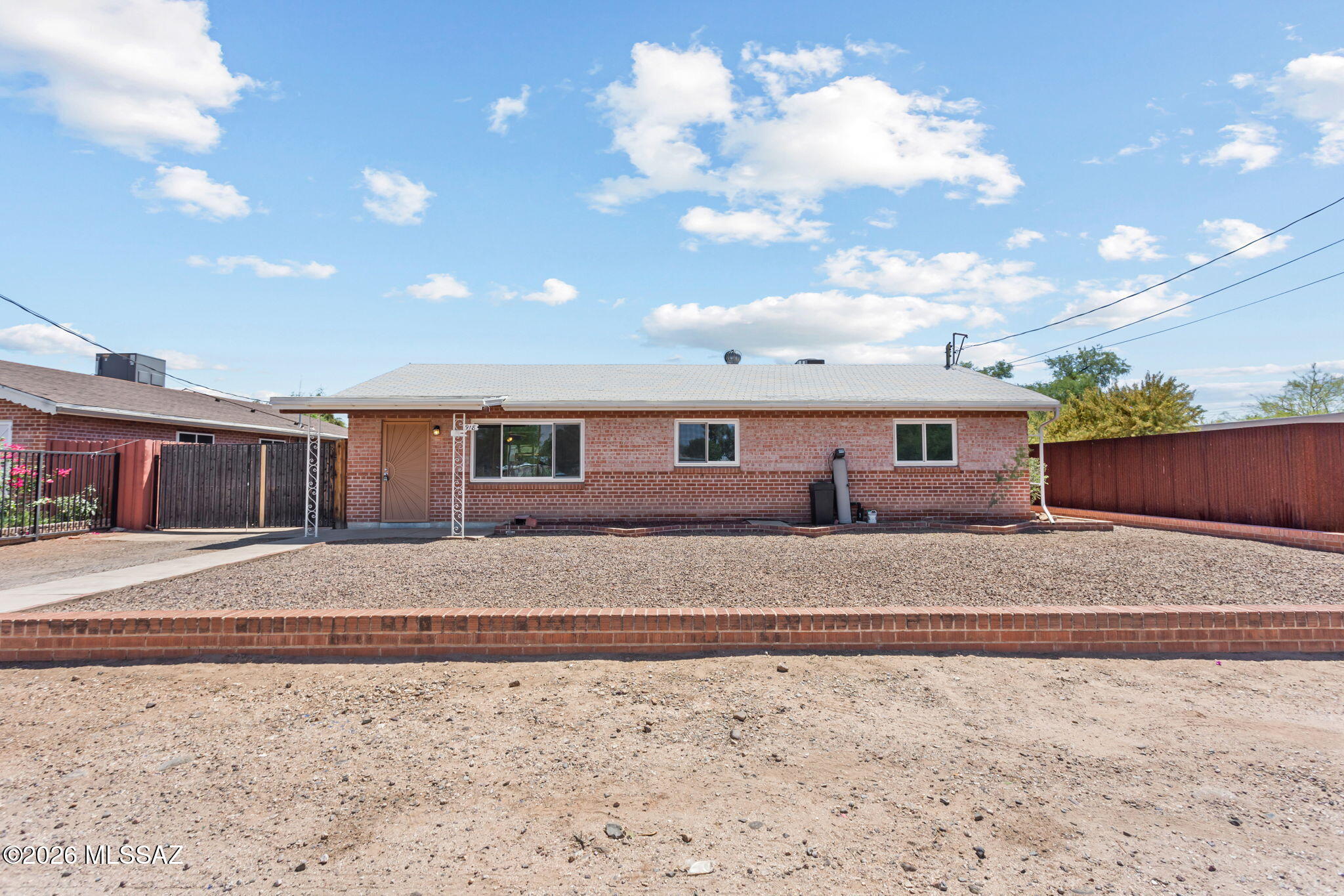 Range price $250,000-$275,000. Charming 1959 brick ranch home offering timeless character and modern functionality. This well-maintained 3-bedroom, 2-bathroom home is freshly painted with a newer HVAC unit and is move-in ready, featuring front-facing mountain views.  Situated on a nearly quarter-acre lot, the spacious backyard offers plenty of potential and includes a one-car carport and/or workshop. Equipped with an updated 16-point wired data system, the home is internet-ready in every room--ideal for remote work or home office setups. With no HOA, you'll enjoy added flexibility and fewer restrictions.  Conveniently located near shopping, dining, and just 10 minutes from the University of Arizona, this property combines classic construction, modern upgrades, and everyday convenience.