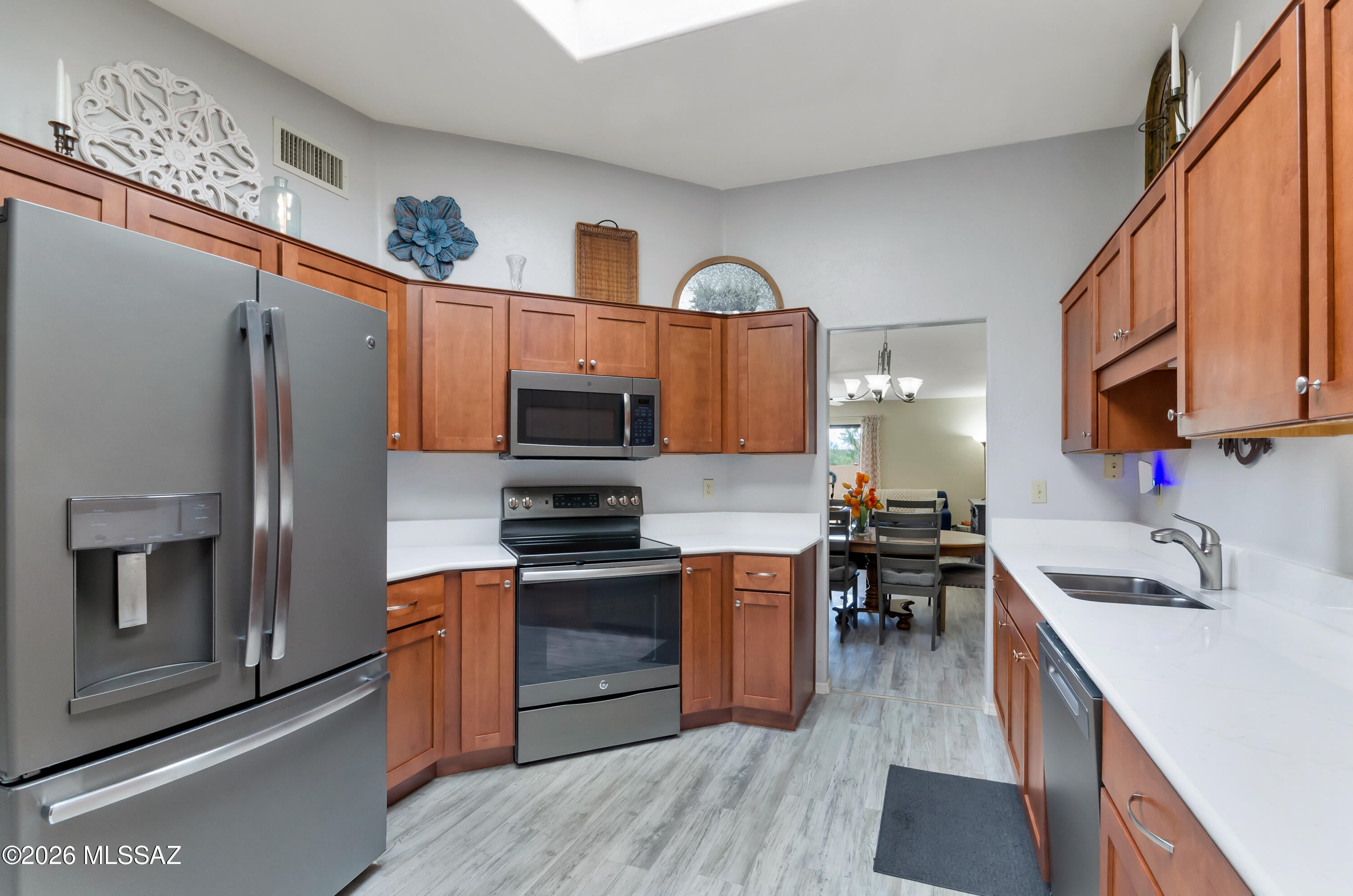 Welcome to NW Tucson Townhome living as it was designed to be enjoyed. This beautiful Townhome has been lovingly updated to include Kitchen cabinet refinish, luxurious white quartz counters, pull out shelves, plenty of drawers, ample cabinet pantry, new sink, garbage disposal, and newer dishwasher. The luxury vinyl plank & newer carpet complement the soft interior neutral colors. The 7 skylights are unmatched & provide the right natural lighting. New Garage Door/Opener. Newer HVAC. The Den/Office has direct access to the garage. Orange Citrus Tree delights. This Casas Adobes neighborhood is like resort living. Close to shopping, restaurants, entertainment, schools & medical care. There is no through traffic. Enjoy privacy and quiet living. Comm. Spa/Pool/Exercise Facility all included.