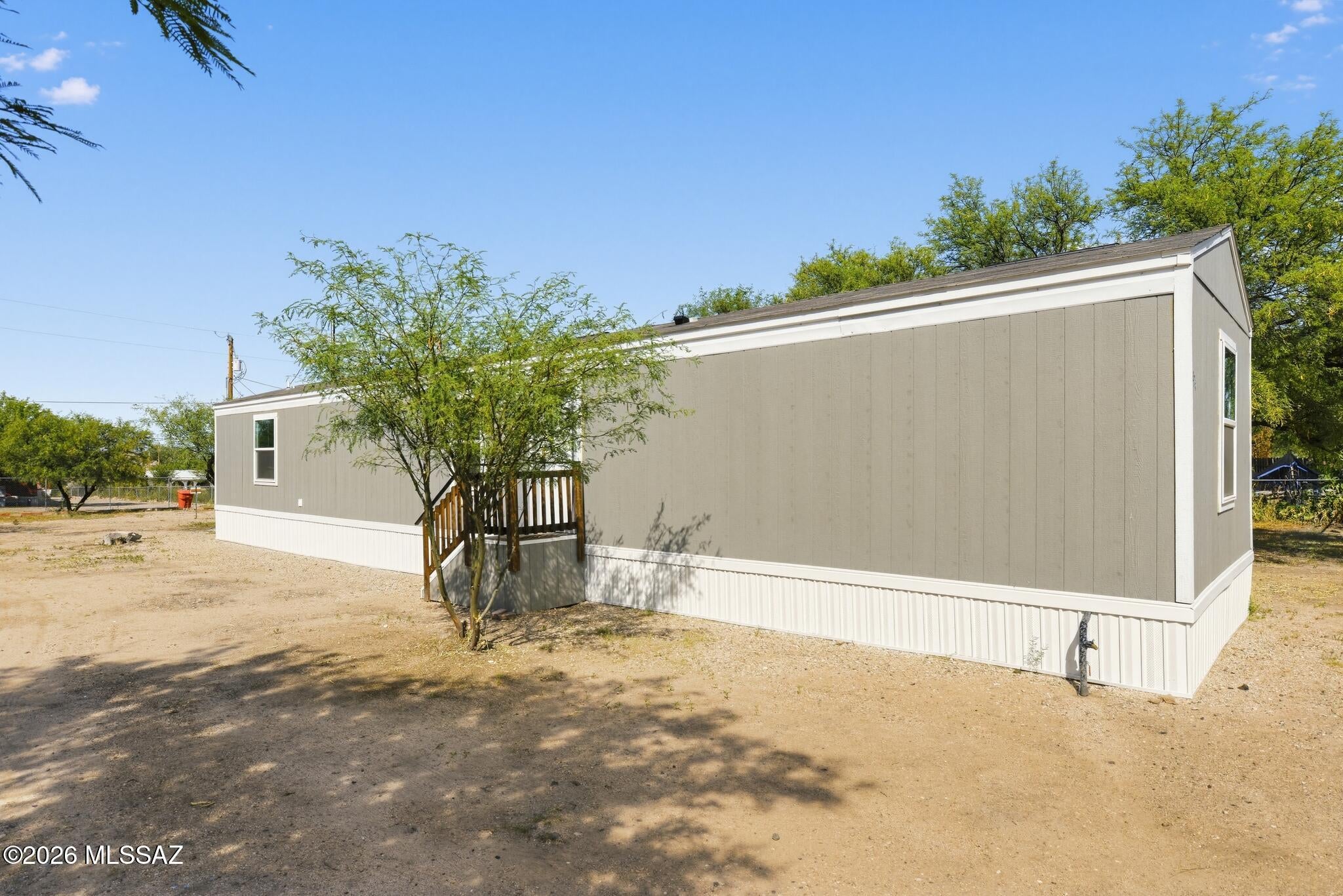 2024 Clayton single-wide in central Benson! 902 sq ft with 3 bedrooms and 2 bathrooms, featuring an open floor plan, all-electric utilities, central A/C, and a dedicated laundry room. Nearly new with existing warranties for added peace of mind. The property offers several mature mesquite trees providing shade and a pleasant outdoor setting. Conveniently located near local shops, dining, and amenities. Move-in ready! Seller is licensed to sell real estate in the state of Arizona