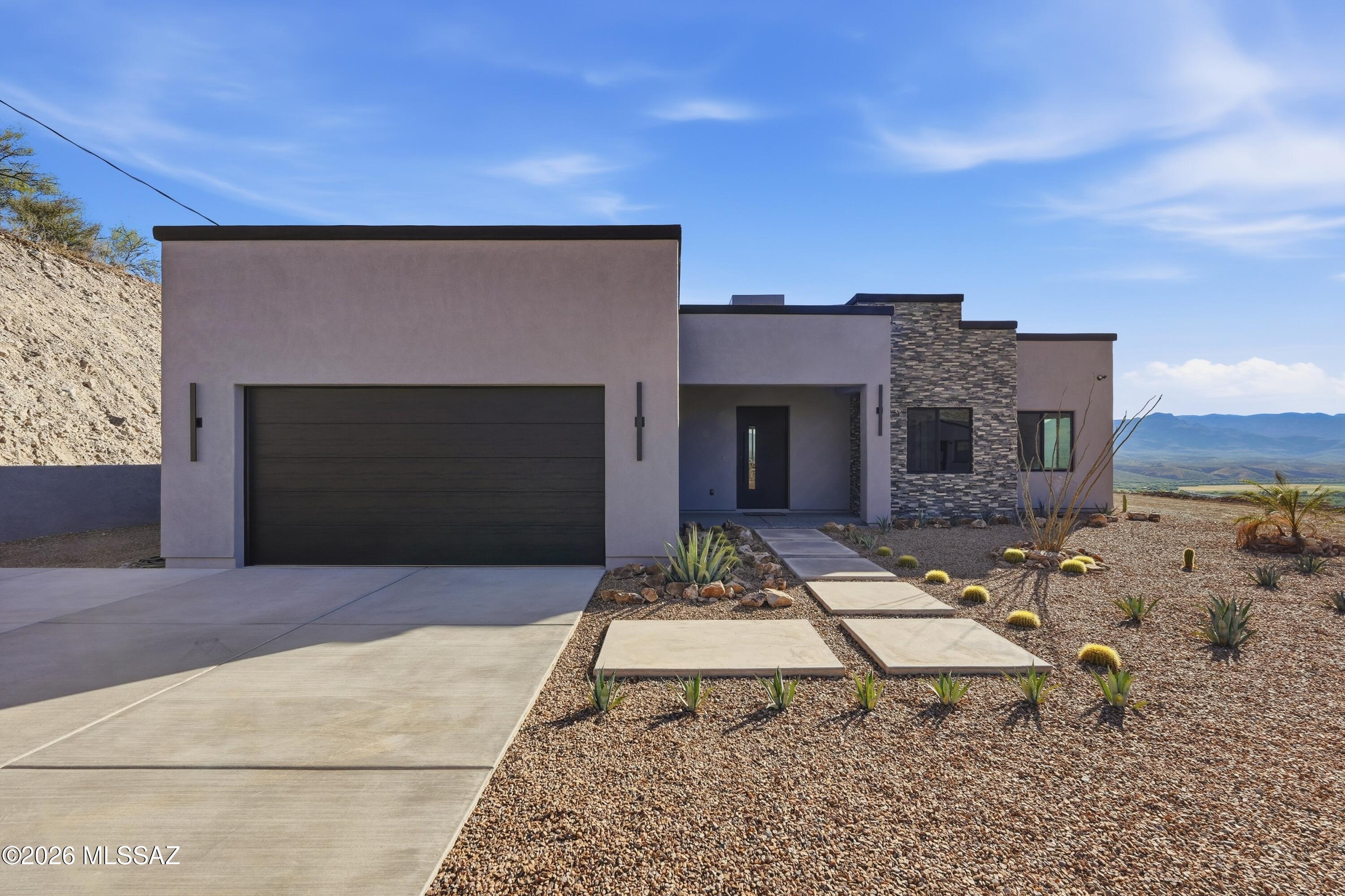 A single-family home designed for unhurried living and effortless hosting, this 4-bedroom, 2-bath residence pairs a generous 1,937 sq ft interior with the rare luxury of a 173,369 sq ft homesite. The result is a place that feels comfortably spacious inside and wonderfully open outside, ideal for buyers who want room to breathe without giving up a refined, highly upgraded living experience. Inside, the home has been thoughtfully enhanced with elevated finishes and modern design throughout. Large-format 24" x 48" porcelain tile flows seamlessly through the entire home, including the showers, creating a clean and sophisticated aesthetic. Soaring 12-foot ceilings in the great room, 10-foot ceilings throughout the remainder of the home, and 8-foot interior doors add volume and openness, while an upgraded interior lighting package featuring additional recessed lighting, modern pendant fixtures, a foyer chandelier, and luxury lighted bathroom mirrors brings warmth and contemporary style to every space.
At the center of the home, the kitchen is designed to impress with 3cm quartz countertops throughout, including a dramatic waterfall island, paired with upgraded Moen fixtures and faucets for a polished, upscale finish. The spacious great room is anchored by a stunning 12-foot stone accent wall with an integrated electric fireplace, creating a natural focal point for relaxing evenings or entertaining guests.
The home's thoughtful layout offers flexibility for a dedicated office, hobby or fitness space, and comfortable overnight accommodations when friends and family visit. Both bathrooms have been tastefully upgraded, including a frameless glass shower door in the secondary bath and high-efficiency modern toilets throughout. High-end black Hunter ceiling fans are installed throughout the home and patio areas, complementing the home's modern aesthetic while enhancing year-round comfort.
Designed to blur the line between indoor and outdoor living, the property features expansive 16-foot x 8-foot four-panel sliding glass doors, two additional 8-foot picture windows, and oversized 8-foot x 8-foot sliding glass doors in both rear bedrooms, filling the home with natural light and opening directly to the outdoor living spaces.
Step outside and the scale of the property becomes even more impressive. A 58-foot full-length covered patio with epoxy-coated flooring and Hunter ceiling fans creates an ideal setting for entertaining, dining, or simply enjoying quiet desert evenings. Professionally installed epoxy flooring extends across both covered patios and into the garage, while the professionally designed landscaping, extended concrete driveway, oversized paver walkway, and paint-matched 10' x 20' utility shed add both beauty and functionality.
The property is further enhanced with professionally constructed block walls finished with stucco and paint, offering privacy and a finished custom-home feel. Modern conveniences include a whole-house 48K water softener with carbon filtration, an under-sink reverse osmosis system, Behr two-tone interior and exterior paint, and a Tesla Level 2 EV charger installed in the garage.
Set across an expansive 173,369 sq ft homesite, the outdoor space offers endless possibilities -- from creating private seating areas and gardens to adding future recreational amenities or simply enjoying the peace and breathing room that comes with owning substantial land.
If you have been waiting for a home that combines thoughtful design, luxury upgrades, and a truly exceptional lot size, this is the opportunity to experience that lifestyle firsthand. Schedule your private showing today and discover the space, comfort, and elevated living this property has to offer.