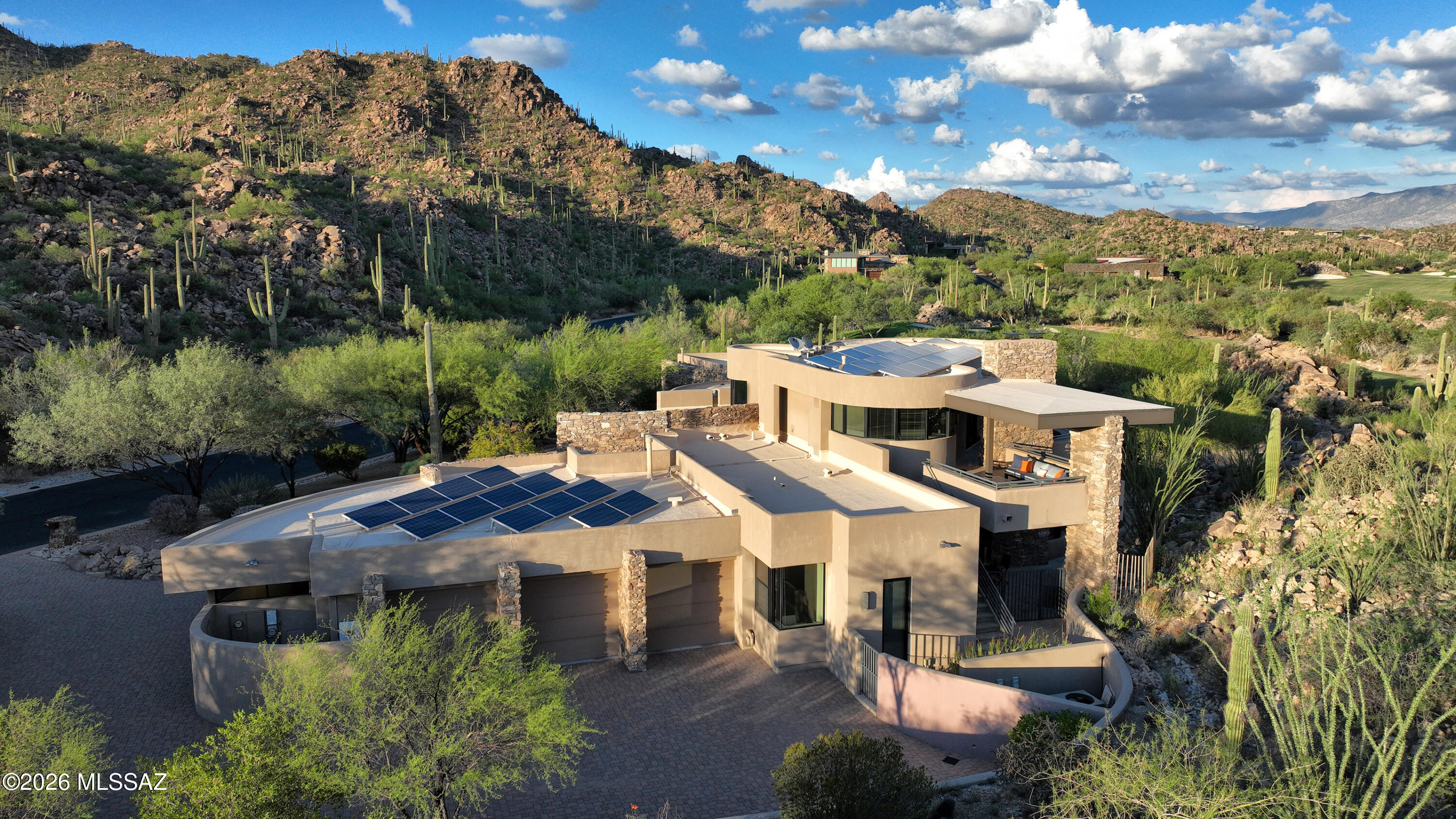 Timeless Contemporary Estate in Stone Canyon: Embrace unparalleled luxury and breathtaking desert landscapes in this exquisite 3-bedroom, 5-bathroom contemporary residence, beautifully situated on a 1.02-acre lot within the prestigious guard-gated Stone Canyon community. Designed by renowned Tucson architect Kevin Howard and built in 2008, this 4,453 sq ft home offers a lifestyle of sophistication and serenity amidst dramatic rock outcroppings and panoramic views of the Catalina Mountains and close up views of the saguaro studded Tortolita Mountains.