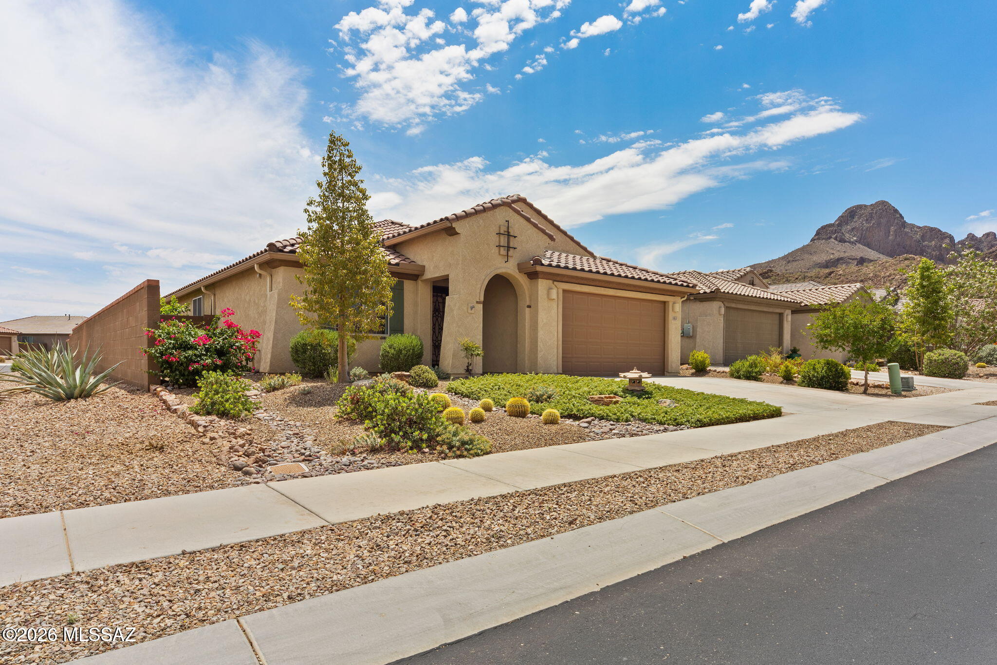 Seller will entertain/counter offers from $550k-$575k. Set against the stunning backdrop of Sombrero Peak, where sweeping mountain views and Sonoran desert beauty surround you, this exceptional home offers a perfect blend of comfort, style, and peaceful Arizona living. Built in 2020 and enhanced with over $63,000 in improvements, this beautifully maintained residence is located within the gated Lazy K Bar Ranch community in Marana and enjoys the added privacy of no neighbors behind.  Featuring 3 bedrooms, 2 bathrooms and a versatile den, this floorplan is thoughtfully designed for everyday living and entertaining. A decorative security door welcomes you inside, where an open great room filled with natural light from a large sliding glass door creates an inviting atmosphere. The stylish kitchen is both functional and impressive, featuring stainless steel appliances, gas cooktop with stainless steel hood, oversized island with breakfast bar, walk-in pantry, and more storage than you could ever need. Tile flooring runs throughout, complemented by upgraded Bull Dog window screens and a Rain Soft Water Conditioning System. The spacious primary suite offers a relaxing retreat with an oversized window, walk-in closet, and ensuite bath complete with dual vanities, walk-in shower, and private water closet. Completing the home is a 2-car garage with epoxy-coated floors, stainless steel utility sink, built-in cabinets, and overhead storage.

Professionally landscaped front and backyards create beautiful curb appeal with mature and young trees, desert plantings, and low-maintenance decorative gravel.
Located in Lazy K Bar Ranch, a community known for its scenic desert setting and proximity to outdoor recreation and trails, this home delivers privacy, mountain views, and refined desert living.