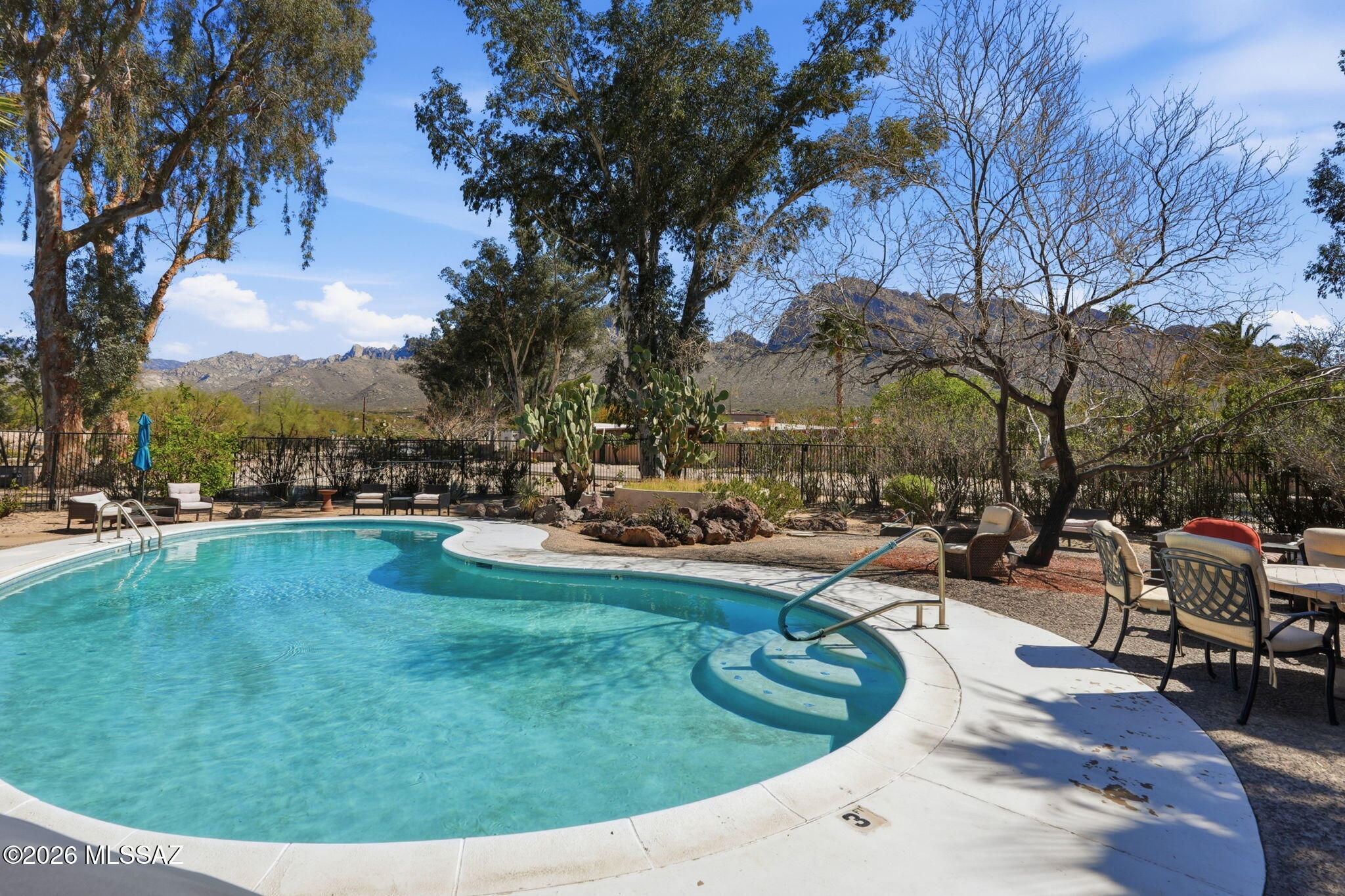 Enjoy peaceful mountain views from this upstairs corner condo in desirable Oro Valley. This charming home offers added privacy and natural light, with a private back patio overlooking a quiet common area and scenic mountains. The unit has been thoughtfully maintained, HVAC replaced in 2021, and refrigerator in 2025. The community is surrounded by mature vegetation and features a relaxing pool area with incredible mountain views-perfect for enjoying Arizona's sunshine. HOA covers roof, exterior maintenance, water, sewer, and garbage to make for easy living.  The property includes one reserved parking space and is within walking distance to The Loop Path, offering miles of scenic walking, hiking and biking trails. Don't miss this opportunity to own a peaceful Oro Valley retreat.