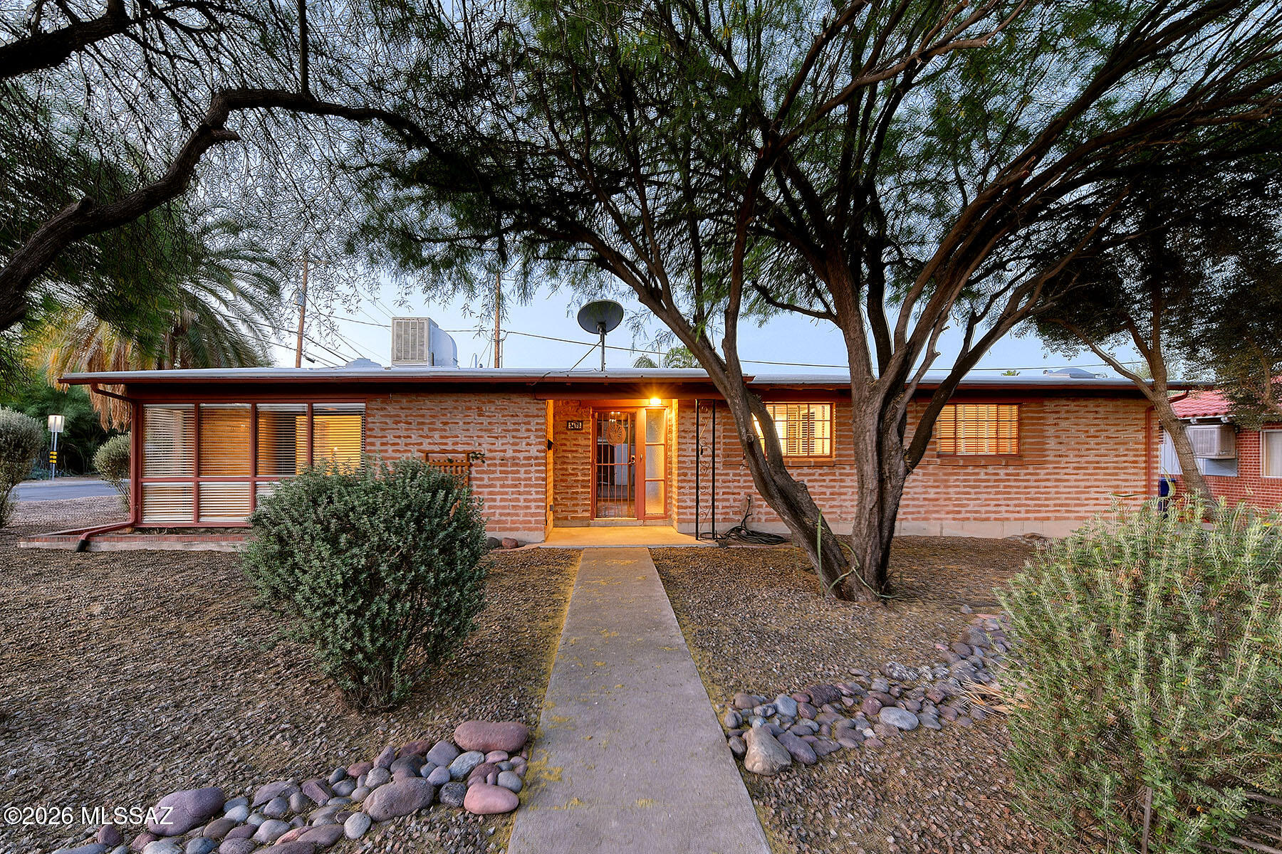 Classic 1950s burnt adobe home with rich character and thoughtful updates throughout. A spacious living room that has vaulted ceilings and a dining room with a fireplace open to the dining area and kitchen, where a breakfast bar and distinctive Mexican tile countertops.
The home offers three generously sized bedrooms, including a primary suite with an ensuite bathroom. Mexican tiled floors, Large floor to ceiling windows, The bathrooms carry through the home's character with Mexican tile shower surrounds and coordinating countertops.
Outdoors, the walled backyard provides privacy and a true retreat, complete with mature landscaping, a covered patio, and a pool ideal for relaxing or entertaining. A large one car garage & off street parking. The roof was recently recoated by Spencer Roofing and includes a transferable two-year warranty.  Walking distance to the El Rancho Center, Whole Foods, The Miramonte, Loft Theatre and more!