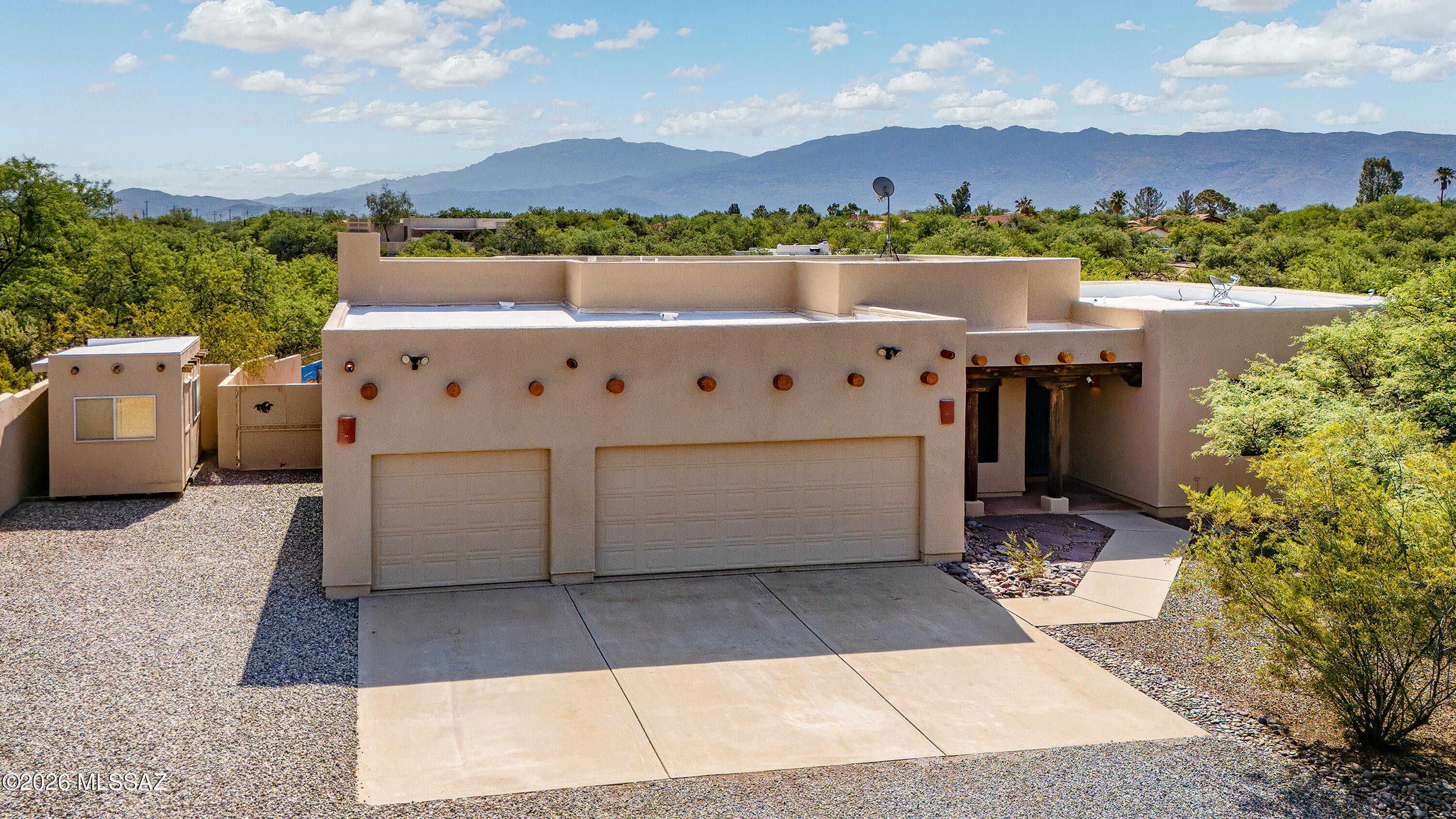 Set on 1.80 acres in the tranquil Tanque Verde Valley, this exceptional property offers the space, freedom, and natural beauty that define the Tucson lifestyle. Surrounded by open desert and framed by sweeping Rincon Mountain and Catalina Foothills views, the setting feels wonderfully private and peaceful, with room to enjoy horses, RVs, outdoor recreation, and wide-open Arizona skies. Equestrian enthusiasts will appreciate the rare opportunity to have a horse arena already in place with lighting and water, along with ample room for horses, equipment, and gear. With no HOA, the property provides the flexibility to truly make the most of the acreage. A 50-amp RV pad with washout, 3-car garage, spacious new Tuff Shed, and two additional storage structures add exceptional versatility for recreational vehicles, desert toys, hobbies, and storage.
Inside, the home is designed to embrace its remarkable surroundings. An expansive wall of windows in the main living area captures beautiful Rincon Mountain vistas, while high ceilings, wood-beamed accents, and warm architectural details complement the natural desert setting. The open kitchen features a striking granite island and countertops, generous workspace, and a farmhouse sink overlooking the private backyard.
A comfortable family room with a corner gas fireplace opens directly to the patio, creating an effortless connection between indoor and outdoor living. Multiple east-facing outdoor spaces invite you to begin the day with sunrise over the Rincons, enjoy coffee in the cool morning air, or simply take in the quiet beauty of the surrounding desert.
The primary suite is a private retreat with its own patio and a spacious, spa-inspired bath featuring a garden tub, oversized tiled walk-in shower with multiple shower heads, dual vanities, and a luxury Toto bidet.
Lush desert landscaping enhances the sense of seclusion while allowing the mountain views and natural surroundings to remain the focus. Newer windows, fresh paint, and updated HVAC systems add comfort and peace of mind.
Whether your vision includes horses, an RV, outdoor entertaining, recreational toys, or simply more room to breathe, this property delivers a rare combination of acreage, functionality, mountain views, and freedom. Peaceful yet convenient, it is a special opportunity to experience the open-space lifestyle of Tucson's beautiful Tanque Verde Valley.