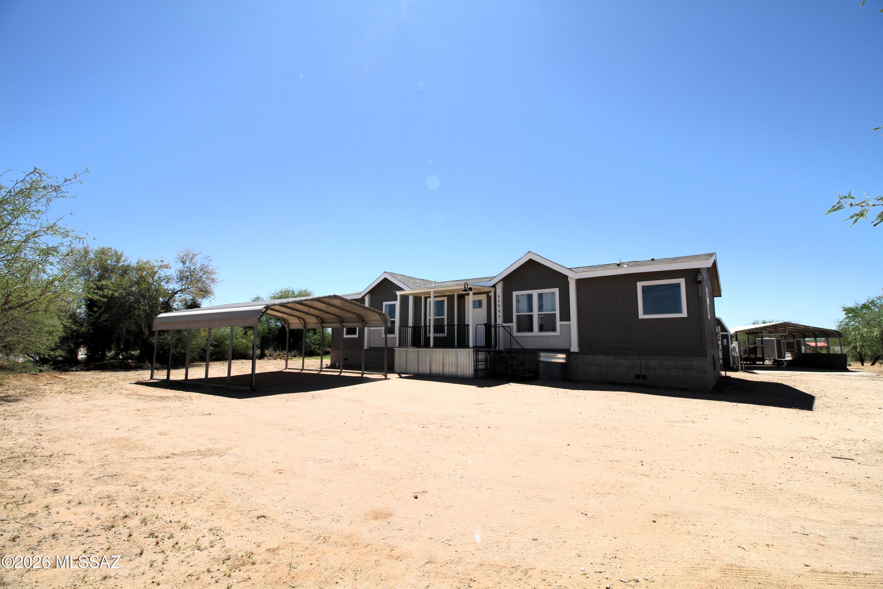 Exceptionally well kept home built in 2022 with great views and privacy. This home has been meticulously maintained and enjoys fresh paint, new carpeting scheduled to be installed first week of April and many more updates. The exterior has covered carport for up to 4 vehicles plus an additional workshop/storage shed wired with lights and outlets that includes a 30 amp with 220 for a welder. Additionally, an extra 200 AMP service panel for 50 and 30AMP RV outlets is available for your Recreational vehicles. Extra interior features include ceiling fans throughout, double vanity in the master bedroom along with a beautiful garden tub with separate shower, and split floor plan for privacy in the main living area. This home must be seen in person to appreciate!