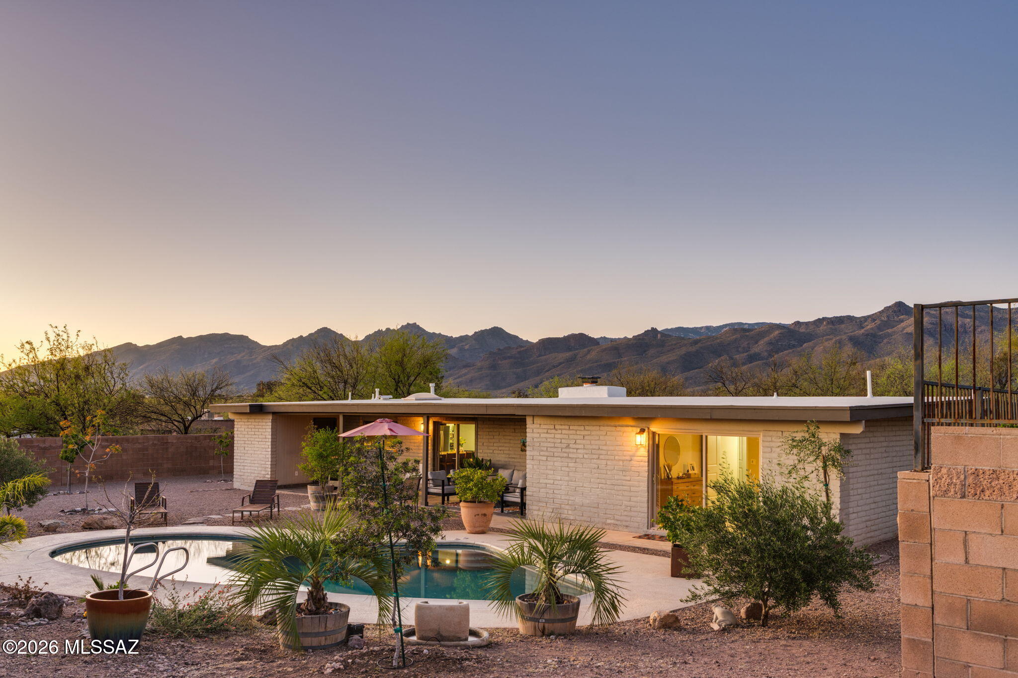 Tucked away on over an acre in the highly sought-after Tanque Verde School District, this private desert property offers space, privacy, & the natural beauty of the surrounding Sonoran Desert. The 4-bedroom, 2-bath home features large bedrooms, a new roof & water heater, and easy-care flooring with no carpet throughout, all complemented by a neutral interior color palette. The open, light-filled floor plan centers around an updated kitchen with a large granite island & a generous walk-in pantry providing exceptional storage & functionality.  The inviting living spaces feature a striking fire place & expansive windows capturing peaceful desert views. A new front door and ceiling fans throughout add comfort and style and are just the beginning of the many updates found throughout the home. Step outside to a private backyard retreat with a sparkling pool, mature landscaping, and a hillside fenced garden area with a variety of fruit trees including plum, peach, pomegranate, mandarin orange, nectarine, lemon, fig, pear, & mulberry. The expansive acre+ lot offers ample space for horses, RV parking, and additional outbuildings. The property has also been enhanced with a block wall, two side gates, and a double gate for convenient boat or RV access and storage. With nearby access to hiking and biking trails, the Sonoran Desert is right outside your door.  Located near Agua Caliente Park and the base of Mt. Lemmon and just minutes away from shopping, dining and schools. No HOA required, with a voluntary option available.  Feature sheet added for additional upgrade information. This is a must see!