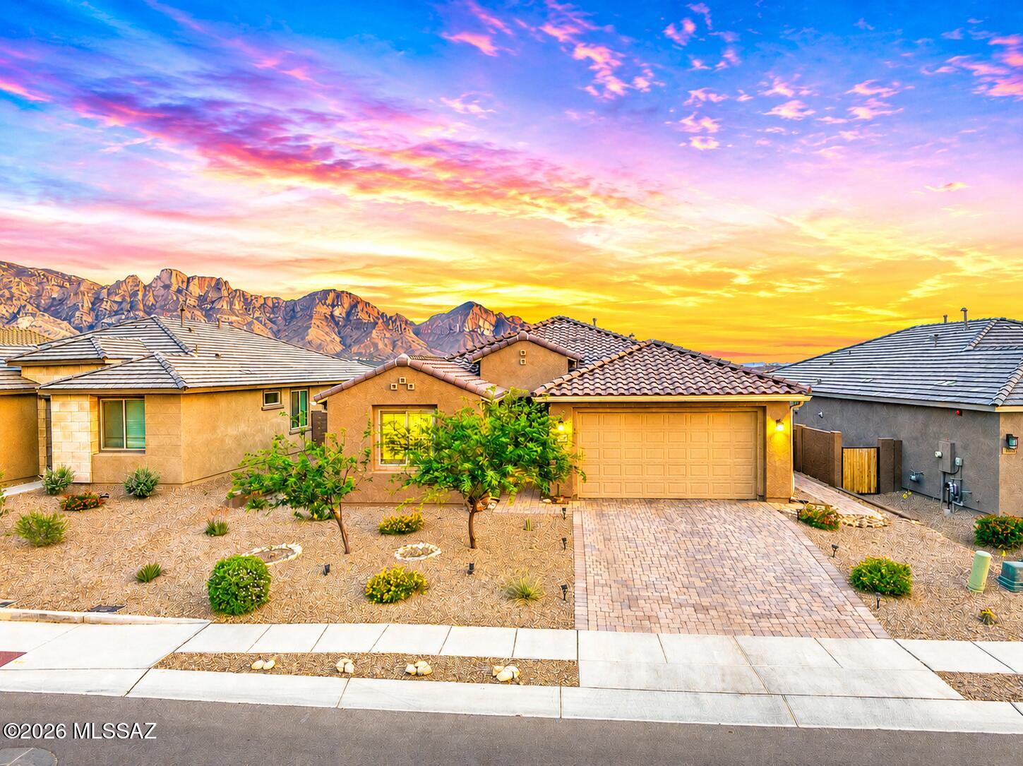 Located in gated Vistoso Canyon Estates in Oro Valley, this stunning 2024-built one-story home offers luxury living w/ breathtaking Catalina Mountain Views. This 2,060 sq. ft., bright, open floor plan has 3 BR + Office, split bedroom design and 12x24 tile throughout. Beautiful Spanish elevation, paved driveway & walkway create exceptional curb appeal. Inside, the gourmet kitchen is designed w/ an oversized island, stainless appliances, quartz countertops & walk-in pantry. The open kitchen flows into dining area & family room where large windows perfectly capture the panoramic mountain views. The owner's suite features views, ceiling fan, ensuite w/ walk-in shower, tub, dual sink vanity & walk-in closet. Step outside to covered patio, professional landscaping, fenced yard & Mountain Views!