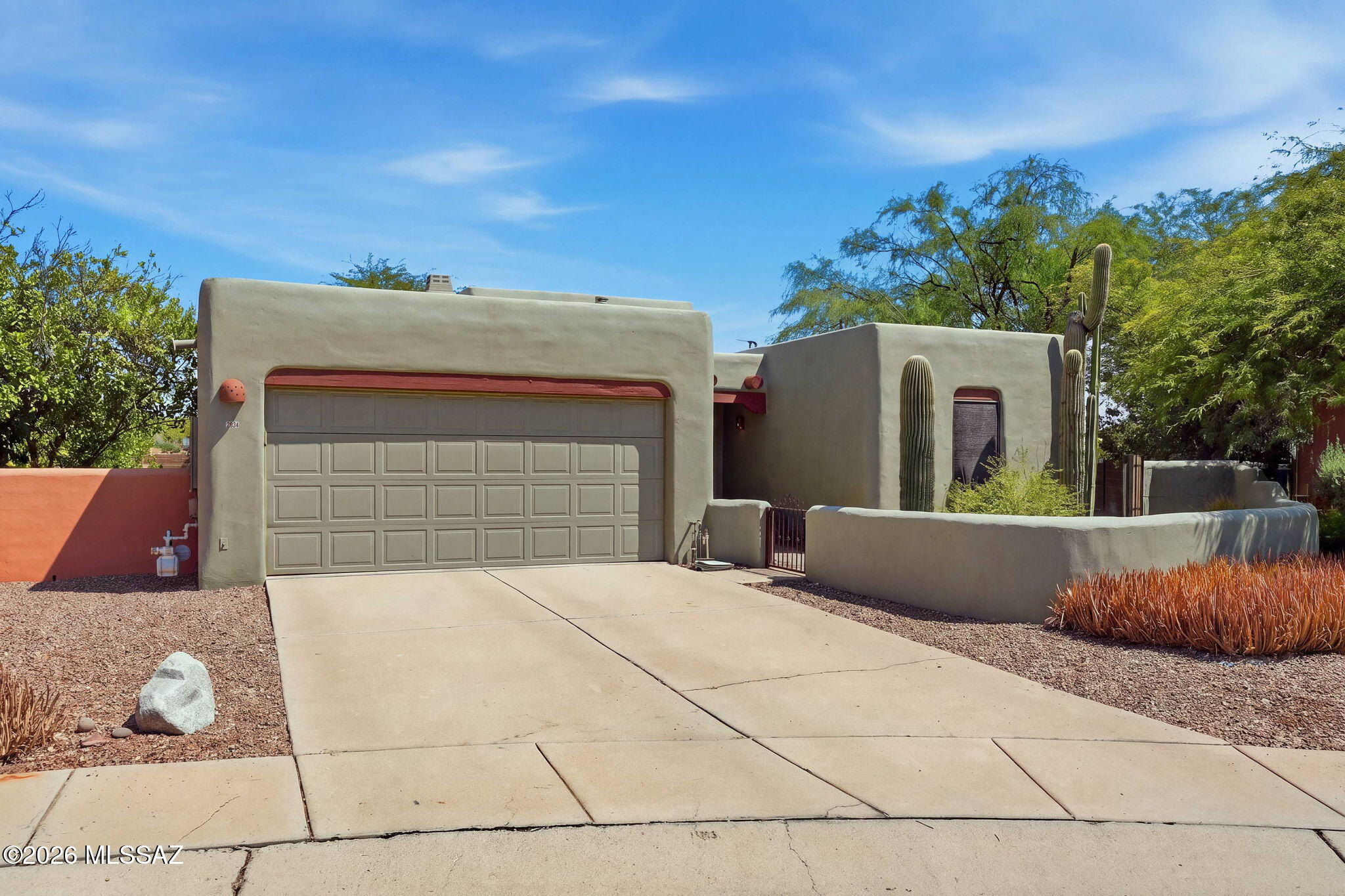 Gorgeous Sante Fe on .21 Acre cul-de-sac lot with no rear neighbor and fantastic desert and mountain views. Soaring ceilings with stunning wood beams inside and out of this desert beauty! Private, quiet, just north of the Omni Tucson National Golf Course and close to everything you need. Split floor plan with large primary suite with a private patio. Wrap around covered patio with stunning wood accents leads into a beautifully landscaped yard with a fluffy patch of grass, countless trees and thriving bushes. The perfect yard to quietly enjoy everything the desert has to offer from hummingbirds to monsoons! Home offers formal living room with lovely beehive fireplace, a formal dining room, and a great room including a spacious kitchen, eat in dining area and family room. New HVAC 2025 year old in this very well-maintained home!