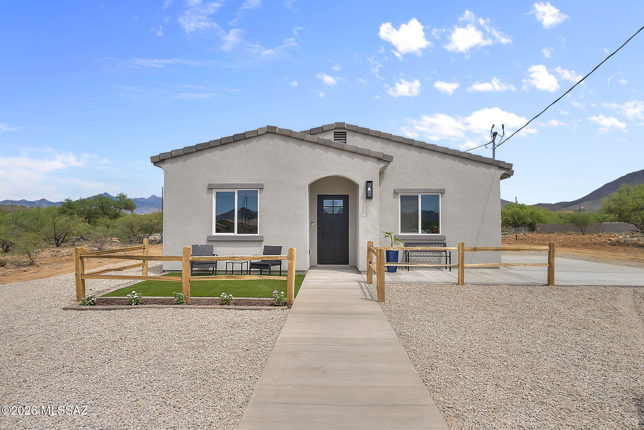 Welcome to your perfect first home, nestled on a quiet cul-de-sac at 1801 Rusia Court in Rio Rico. Sitting on a flat and fully usable .26-acre lot with sewer connection. This property offers the space, comfort, and flexibility you've been looking for. As you step inside, you're welcomed by an open living and dining area that feels bright, spacious, and easy to make your own. Ceramic tile flooring throughout means low maintenance and durability ideal for busy, everyday living. The modern kitchen is both stylish and functional, featuring white cabinetry, sleek black hardware, soft-close drawers, quartz countertops, and black stainless steel appliances. The bedrooms are generously sized, giving you flexibility for guests, a home office, or growing needs. The primary suite offers a comfortable retreat with a large walk-in shower, custom vanity, gold finishes, and a modern mirror that adds a touch of convenience to your daily routine. Outside, the ranch-style design with a stucco finish and tile roof gives the home timeless curb appeal, with decorative rock accents, and turf makes landscaping simple and low upkeep. The spacious backyard is a blank canvas, and perfect for adding a patio, garden, play area, or anything else you envision as you make this home your own. Whether you're starting your homeownership journey or looking for a move in ready space with room to grow, this home checks all the boxes.Extra bonuses included camera door bell, key pad entry, wooden front fence, and a large concrete pad for parking.