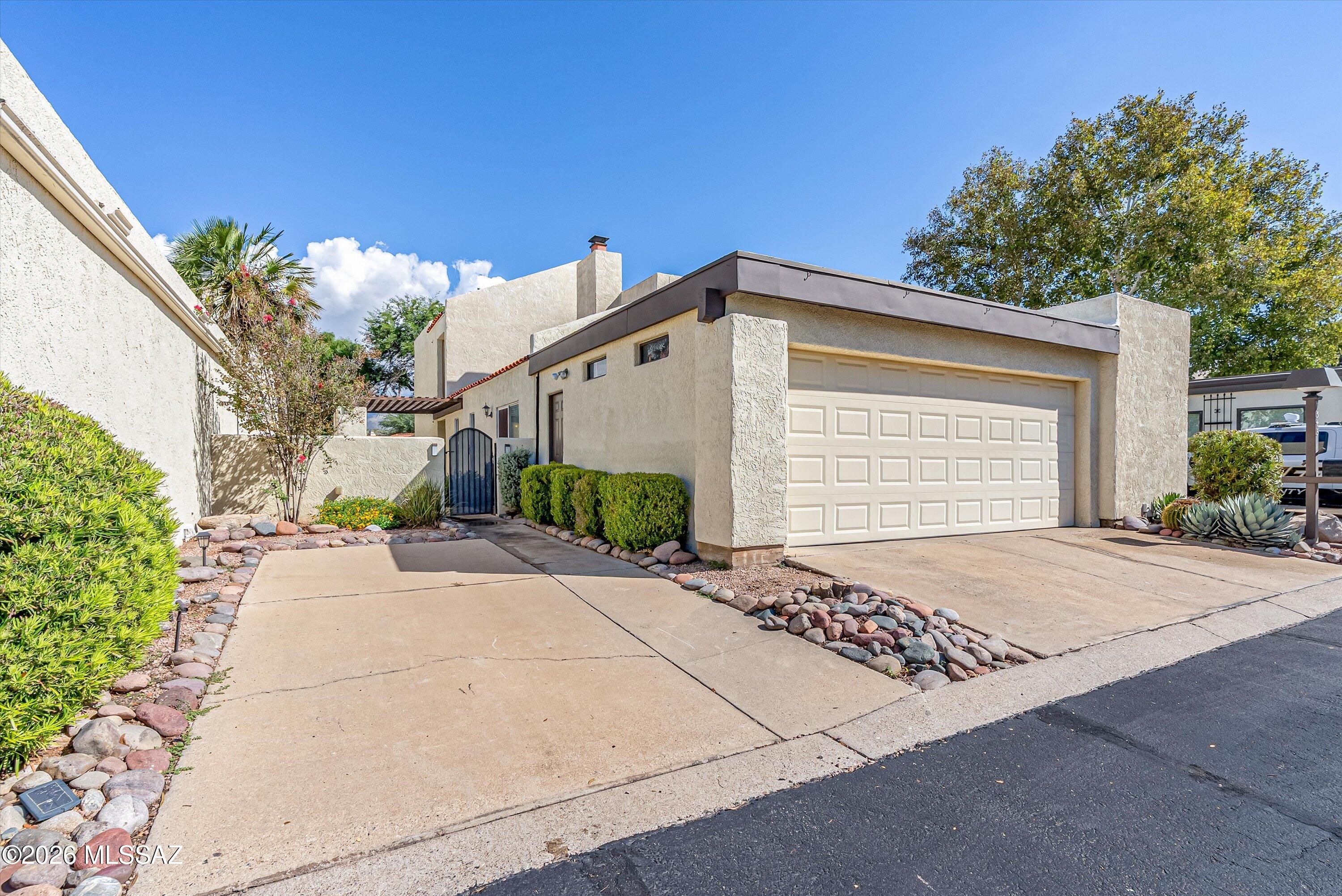 Look through the trees toward the Catalina Mountains from the primary suite's brand-new balcony, and you will feel like you are living in your own private, elevated treehouse. Set in desirable Villa Del Rio off Sabino Canyon Road--a quiet, walkable, pet-friendly enclave listed on the historic register--this lovingly maintained 4-bedroom, 3-bath townhome offers timeless character with turn-key modern convenience. Two main-level bedrooms and a full bath provide seamless flexibility for a home office or guest suite.
Thoughtfully updated throughout, the interior features custom kitchen cabinetry, a custom California Closet in the primary suite, ample hidden under-stairs storage ideal for holiday decorations, and a serene center atrium complete with a water fountain. Core upgrades include a newer HVAC system and water heater, whole-home water softening and filtration, and a 2-car garage with an adjacent storage room. Enjoy elegant, quiet living just moments from prime foothill dining, shopping, and entertainment, with easy access to the University of Arizona, Davis-Monthan Air Force Base, and Tucson International Airport.