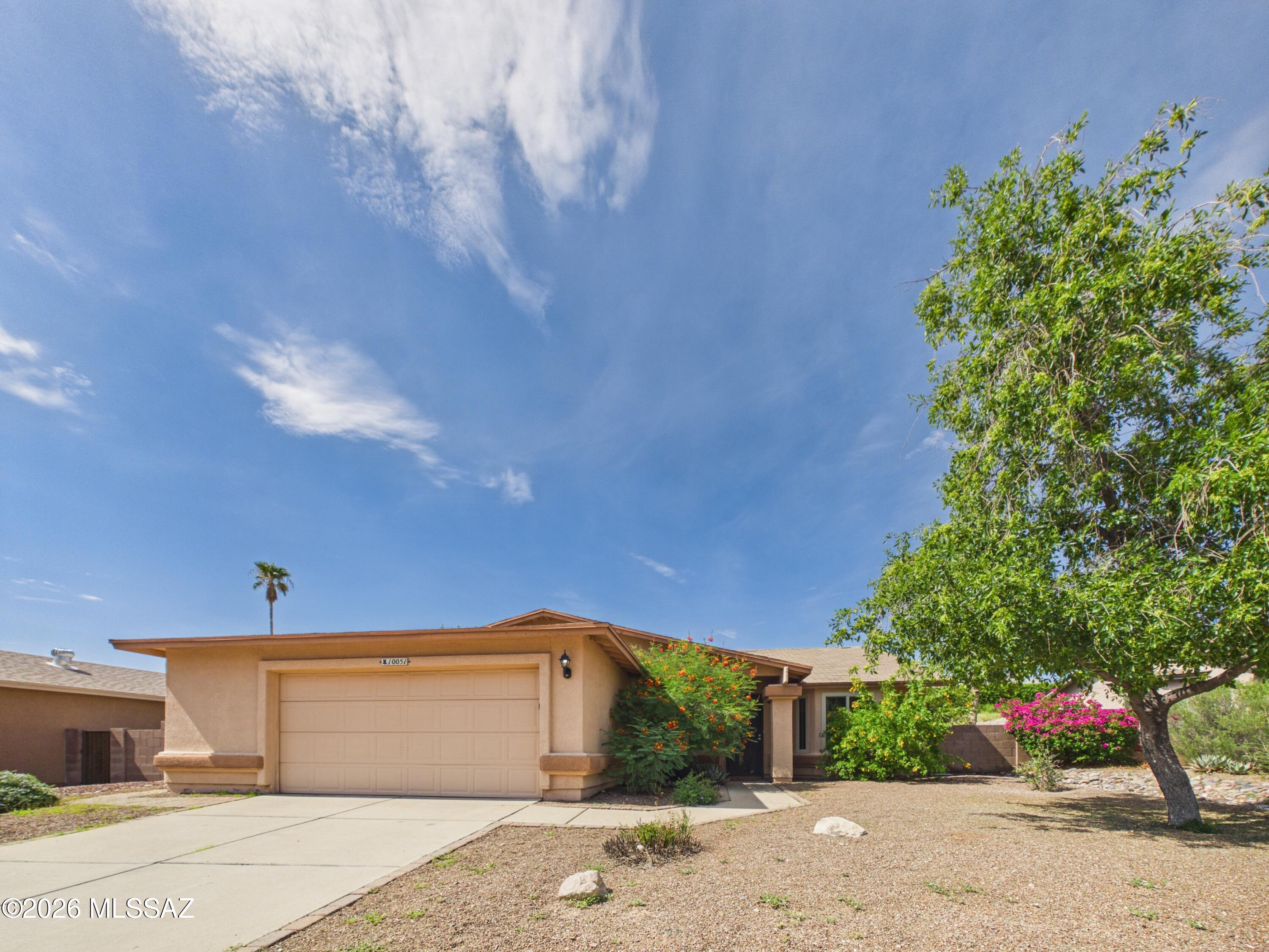 Discover comfort and convenience in this beautifully maintained 3-bedroom, 2-bath home in the desirable Falcon Point community. This single-story home offers 1,576 sq ft with vaulted ceilings, two spacious living areas, and a cozy wood-burning fireplace. The functional kitchen features abundant counter space and opens to the family room, while the private primary suite includes a soaking tub and double vanity. Enjoy a covered paver patio, low-maintenance backyard, and 2.5-car garage. All conveniently located near shopping, dining, schools, parks, and Davis-Monthan Air Force Base.