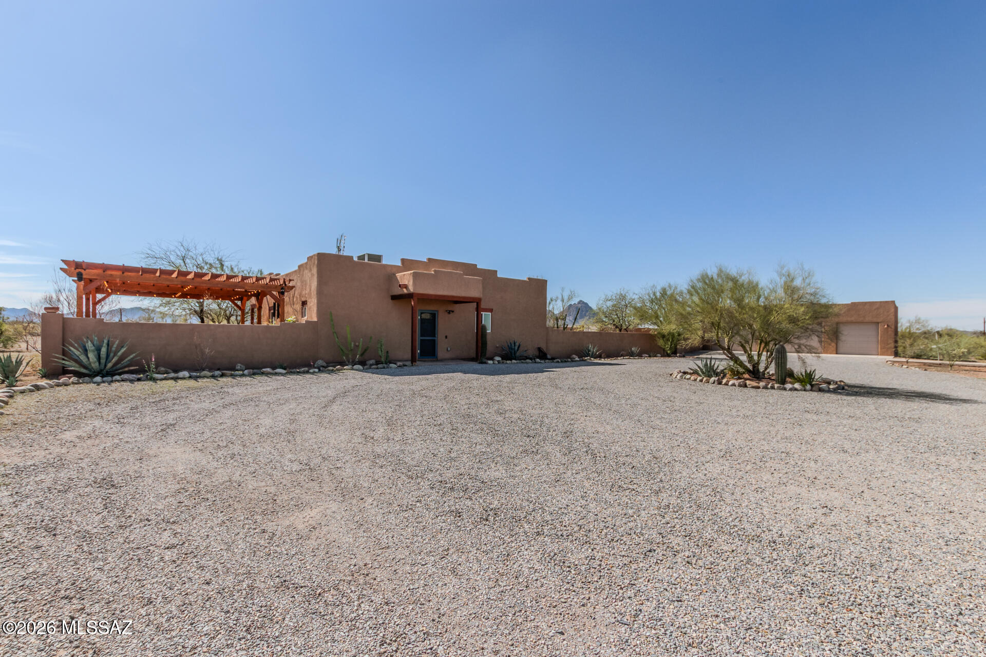 First time on the market! Situated on 4.96 acres with no HOA, this well-maintained property offers space, privacy, and versatile features. The home includes kitchen appliances (micro excluded), water softener, 2 Beds, 2 baths with walk-in showers.. A spacious 3-car garage workshop with AC/heat, insulated ceiling, and 220 outlet. Enjoy outdoor living with a  side patio & large back patio w/ shades. Additional features include a greenhouse with electric and water, chicken coop/additional greenhouse space, block-walled storage shed, rainwater catcher, & desert willow planters. Sellers are leaving the charming living room corner nook. 1 yr Termite & Home Warranty, Ask for list of upgrades too many to list. Bring your RV and enjoy the possibilities this unique property offers. Immaculate home. Bring your RV and enjoy the possibilities this unique property offers.