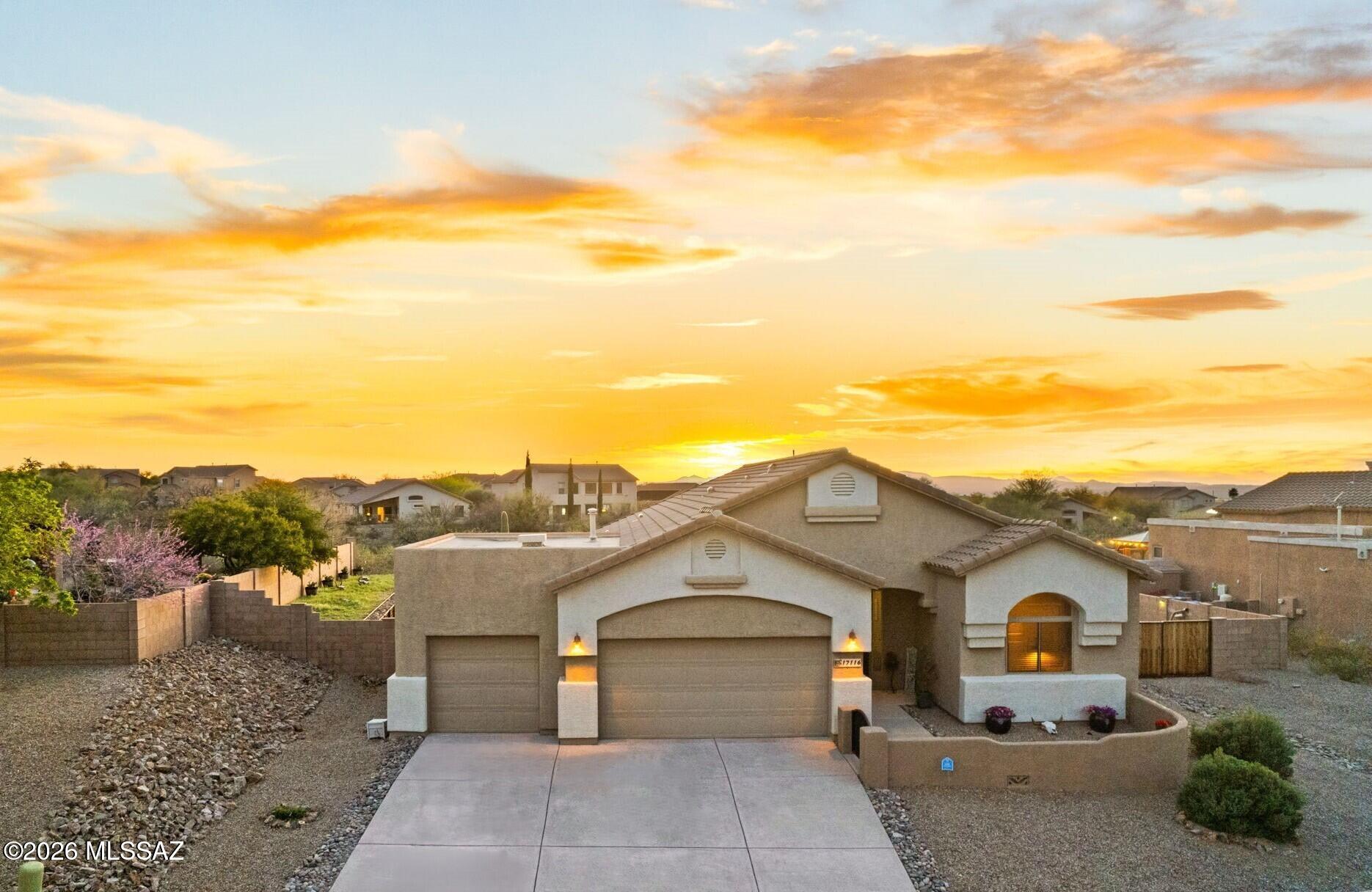 Exceptional Canoa home set on a sprawling .31-acre premium homesite with a view fence overlooking the natural Sonoran Desert common area beyond, creating a peaceful backdrop and enhanced sense of privacy. The resort-style backyard is designed for both relaxation and entertaining, highlighted by a sparkling pool featuring a built-in in-water sitting area with an umbrella sleeve perfect for shaded lounging or enjoying a cool drink while gathering with friends. An inviting courtyard entry welcomes you into the home, where a modern, light-filled open floorplan blends contemporary comfort with a desirable split-bedroom layout that offers both connection and privacy. The spacious great room serves as the heart of the home, providing seamless flow for everyday living and effortless entertaining The upgraded kitchen is both stylish and functional, featuring granite countertops, stainless steel appliances, a generous center island with bar seating, and clean, modern finishes designed for casual gatherings and daily enjoyment.

The thoughtfully designed split floorplan offers a private and peaceful owner's suite, complete with a beautifully upgraded fully tiled shower, dual vanity, and a spacious walk-in closet. Additional bedrooms are positioned on the opposite side of the home for added privacy.

Outdoors, the backyard continues to impress with a covered patio, custom paver patio areas, and expansive play space beyond the pool, along with a raised metal and rock garden bed. A double gate provides convenient access for parking recreational vehicles or outdoor toys, and the oversized 3-car garage offers additional storage and flexibility.

Located in the desirable Sycamore Canyon community in Corona de Tucson, the neighborhood was thoughtfully designed to preserve the surrounding desert landscape, with over 1,100 acres of protected open space. Residents enjoy nearby walking, biking, and hiking trails while maintaining convenient access to Tucson's southeast employment centers and amenities. The home is also located within the highly regarded Vail School District, one of the most sought-after districts in Arizona.